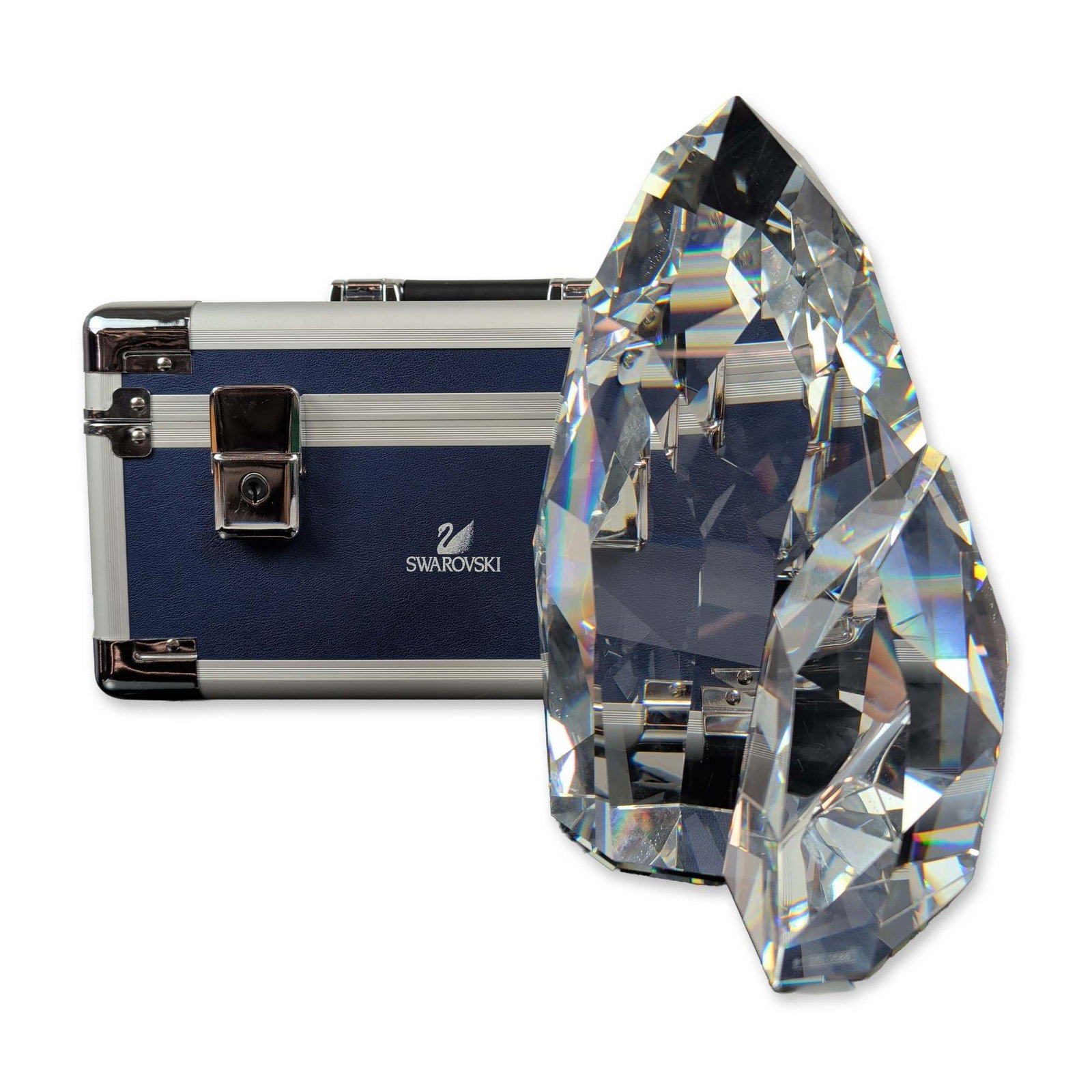 Swarovski Crystal by Mario Dilitz Sculpture, Iluliac Iceberg: Iluliac Iceberg sculpture in clear faceted lead crystal, featuring an elongated geometric form designed to maximize light refraction. Laser-etched on a base facet with the Swarovski swan logo and numb