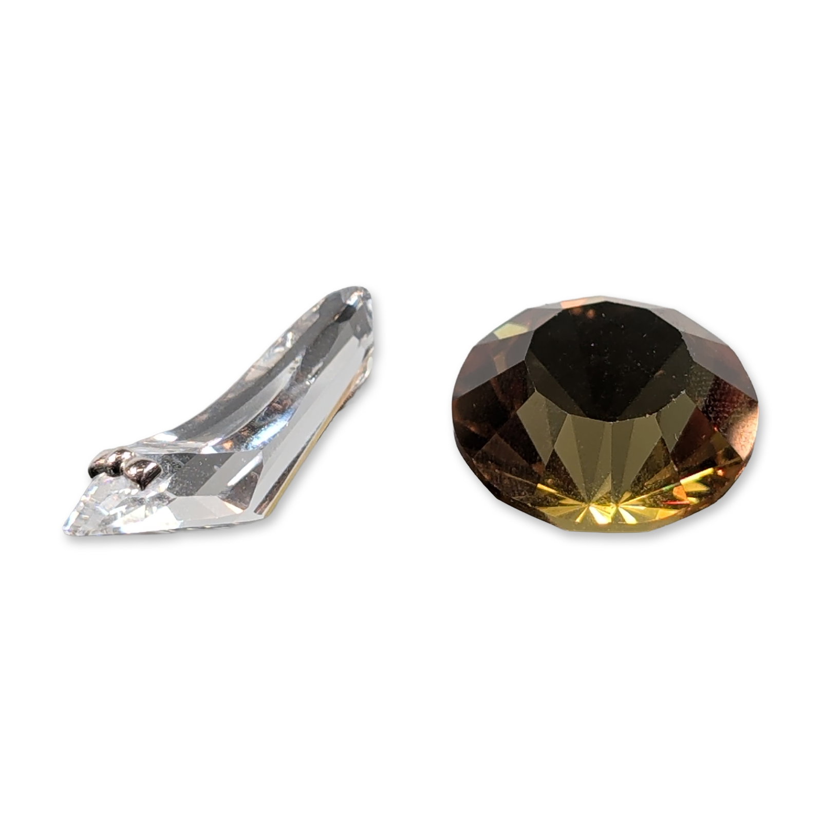 2pc Swarovski Crystal Shoe and Chaton Figurines: Faceted lead crystal or glass figurine components, featuring a elongated colorless shoe joined by a silver-toned metal bridge and a faceted smoky amber tone diamond. The pieces exhibit multiple facets