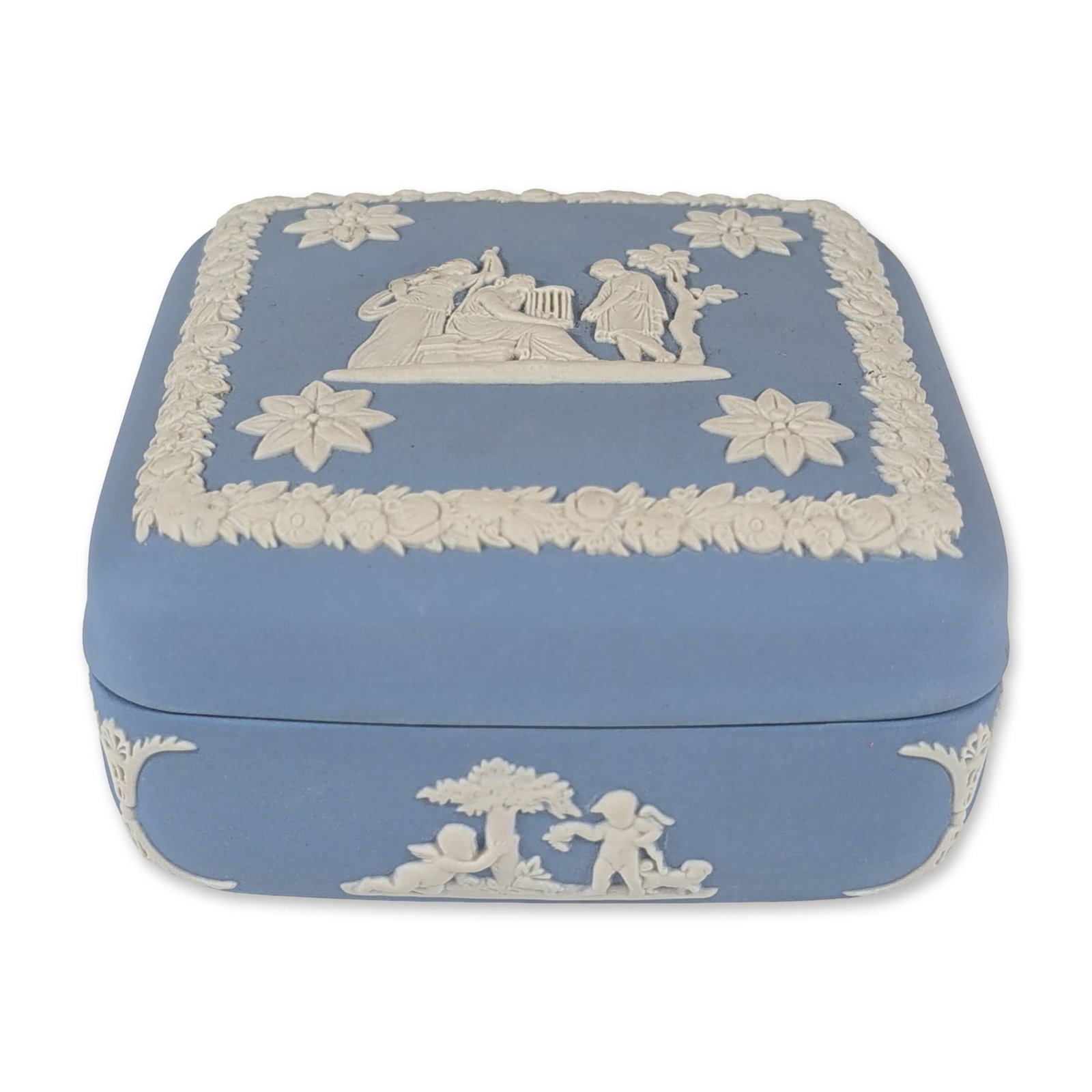 Wedgwood Blue Jasperware Square Treasure Box: Wedgwood. Square trinket box in pale blue Jasperware featuring white bas-relief neoclassical decoration. The lid displays a central cameo scene of figures in classical attire beneath a tree, framed by