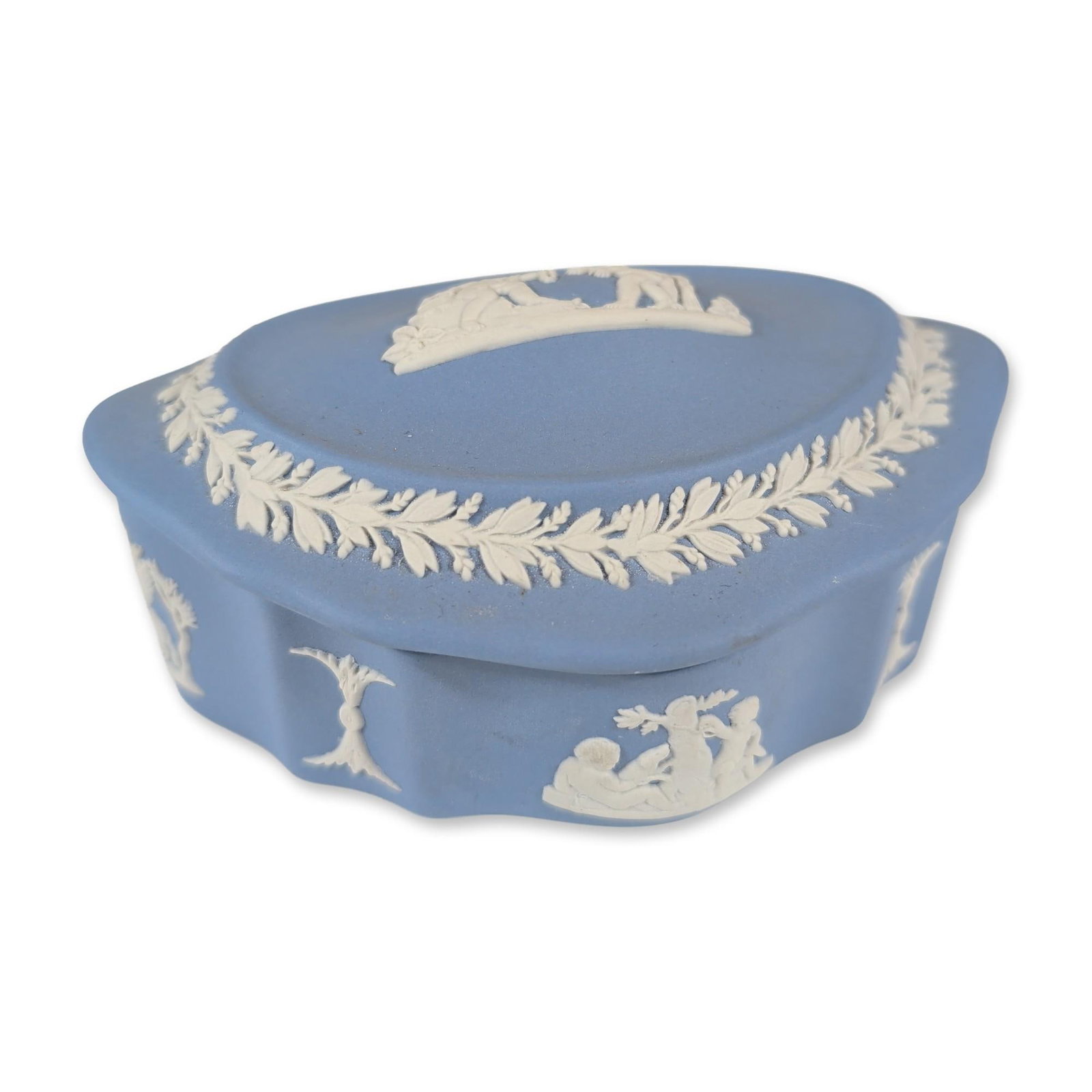 Wedgwood English Blue Jasperware Treasure Box: Wedgwood. Lidded trinket box in pale blue jasperware, featuring white bas-relief classical sprigging. The lid is decorated with a central vignette of figures and a dog within a continuous laurel leaf 