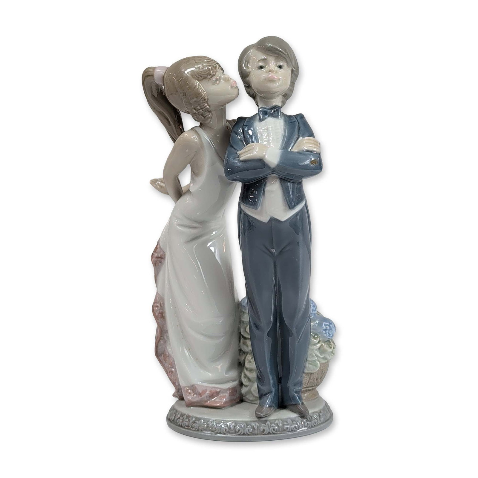 Lladro Porcelain Figurine, Let's Make Up 1005555: Lladro glazed porcelain figurine, titled Let's Make Up, model number 5555. The piece depicts a young couple in formal attire, featuring a boy in a dark blue tuxedo and a girl in a white gown with a pi