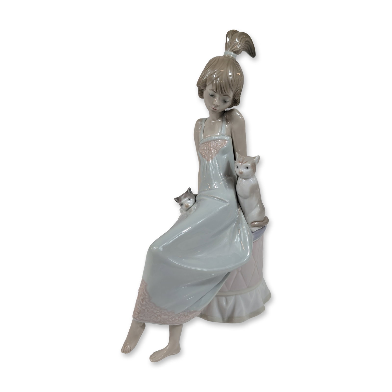 Lladro Porcelain Bedtime 5443 Figurine: Lladro, Spain. Glazed porcelain figurine titled Bedtime, model number 5443, designed by Francisco Catala. The piece depicts a girl with a high ponytail seated on a pale pink quilted ottoman with a ruf