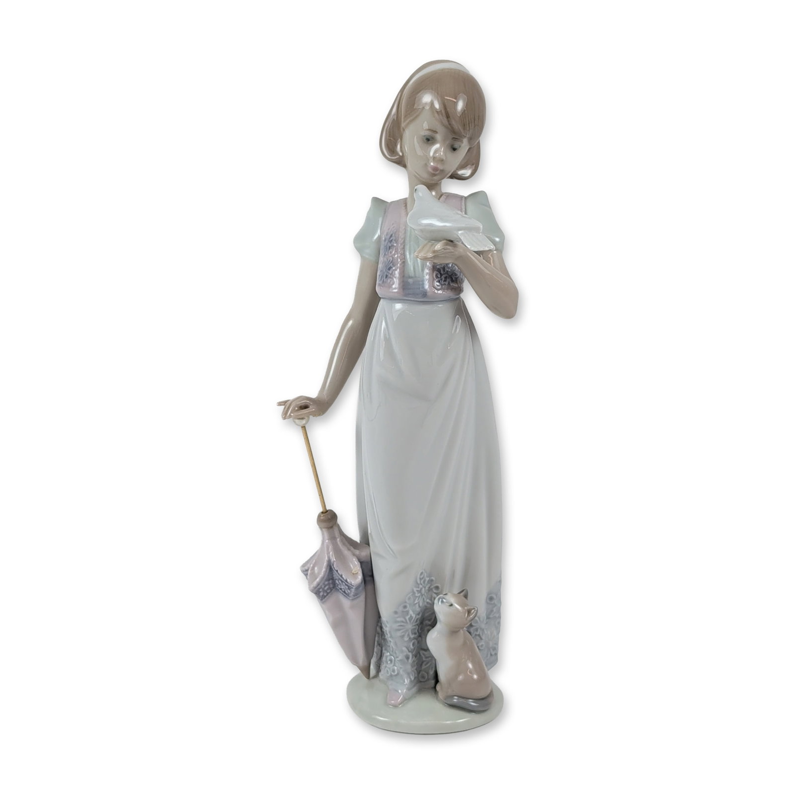 Lladro Porcelain Figurine, Summer Stroll 1007611: Lladro, Spain. Glazed porcelain figurine titled Summer Stroll, model number 7611. The piece depicts a young girl in a long dress with floral lace-like detailing on the bodice and hem. She is posed hol
