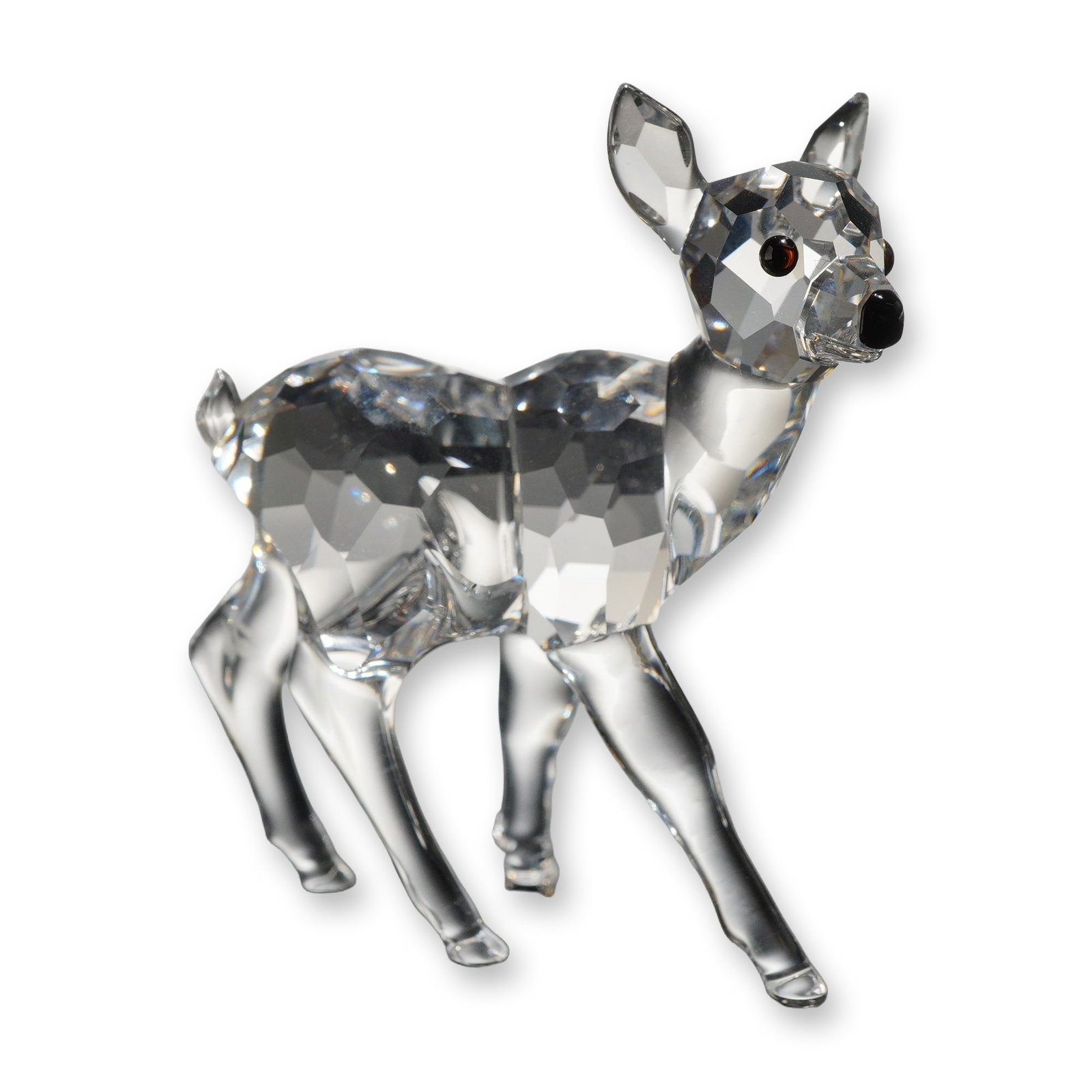 Swarovski Crystal Standing Fawn Figurine: Swarovski clear crystal figurine depicting a standing fawn, model number 235045. The figure features a faceted body, neck, and head, with smooth molded legs and ears, detailed with applied dark amber 