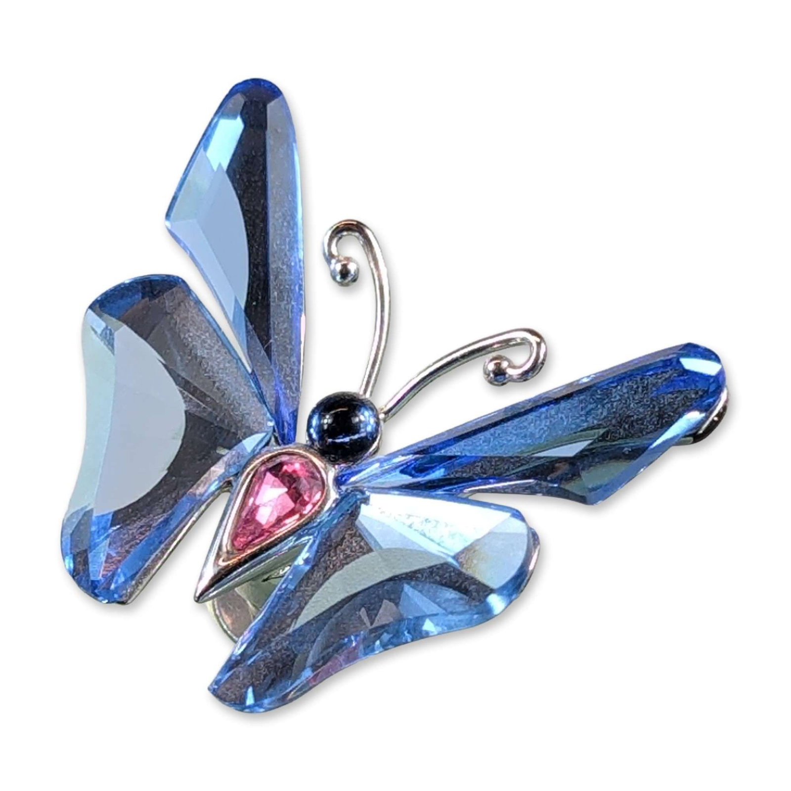 Swarovski Crystal Figurine Paradise Butterfly Ansina Light Sapphire: Swarovski crystal figurine from the Paradise collection, titled Ansina. The piece depicts a butterfly with faceted light sapphire blue crystal wings and a pink teardrop-shaped crystal body, accented w