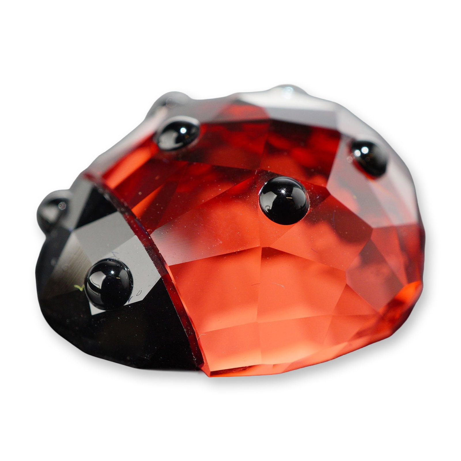 Swarovski Crystal Lucky Ladybug Figurine: Swarovski crystal figurine representing a lucky ladybug, crafted with a faceted translucent red crystal body and six applied black crystal spots, accented by a black crystal head. The flat underside b
