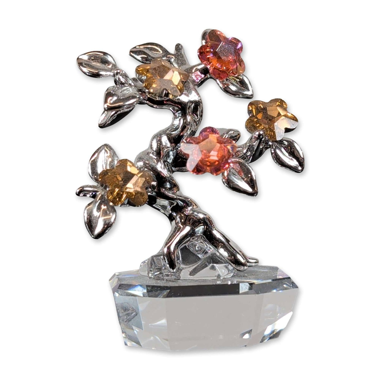 Swarovski Crystal Figurine Memories Rhodium Bonsai Tree: Swarovski. Bonsai tree figurine from the Crystal Memories series, constructed with rhodium-plated metal and multi-colored faceted crystals. The decorative piece features a flowering branch with five c