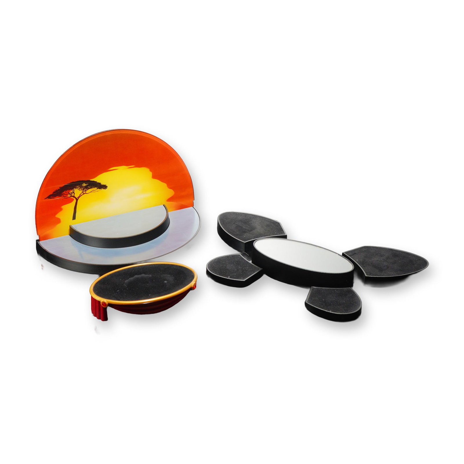 Four Swarovski Display Bases with Boxes: Swarovski. Group of crystal display accessories featuring an Inspiration Africa sunset stand, a five-piece modular display set, a clear acrylic frame, and an oval tiered stand. The Inspiration Africa 
