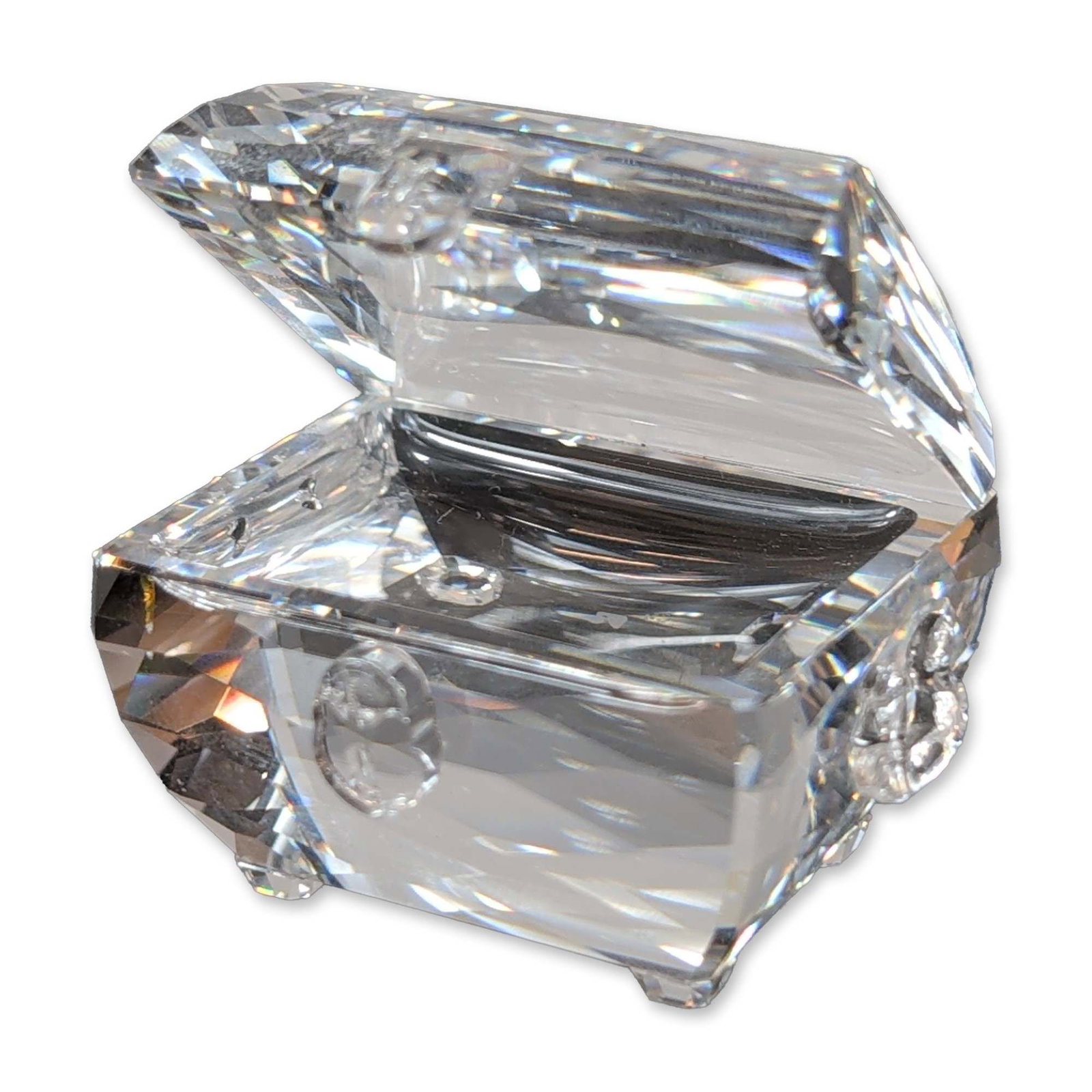 Swarovski Mini Figurine Faceted Clear Crystal Treasure Chest: Swarovski faceted clear crystal treasure chest. Bears the etched Swarovski swan hallmark on a lower facet. Model number 841677. Height 1.75"H. Weight 3.1 oz. Dimensions: 1.75"H Weight: 3.1 oz.