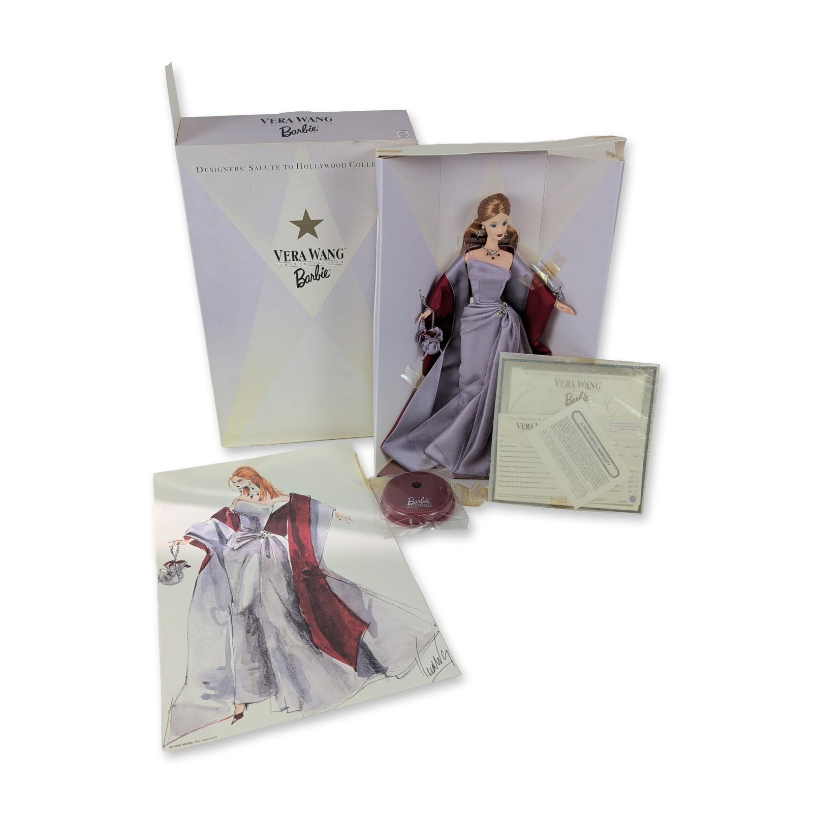 Mattel Vera Wang Designers Salute to Hollywood Barbie: Mattel, Inc. collector Barbie doll from the Designers Salute to Hollywood Collection, 1998. The vinyl doll features rooted auburn hair styled in a side-parted updo and wears an original Vera Wang ense