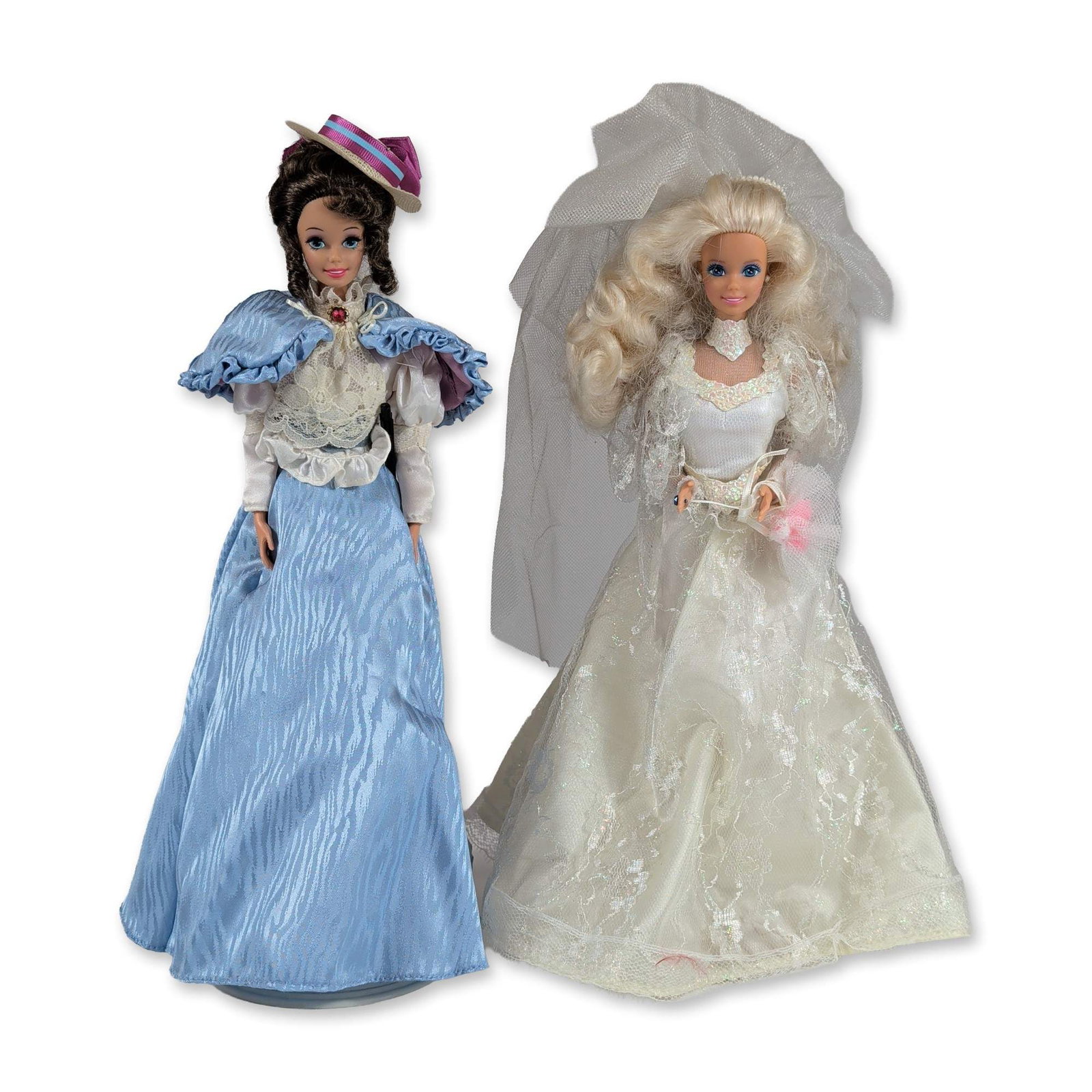 2pc Fashion Dolls in Bridal and Victorian Style Attire: Two vinyl fashion dolls featuring bridal and historical themes. The first doll, resembling a 1990s-era bridal Barbie, features rooted blonde curly hair and fixed blue eyes. The doll is dressed in an i
