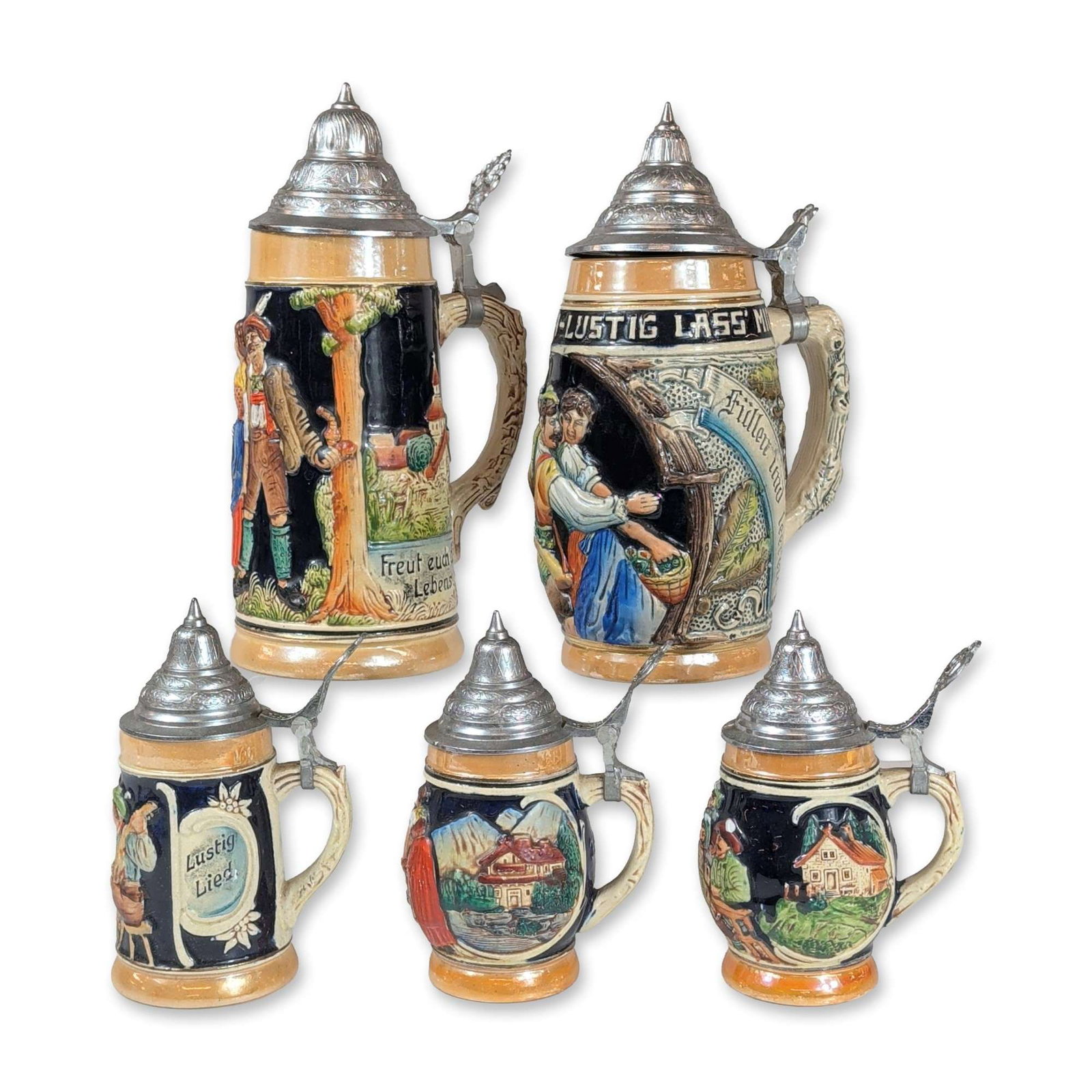 5pc West German Relief-Molded Lidded Beer Steins: West German, mid-to-late 20th century. Set of five lidded beer steins in relief-molded ceramic with polychrome decoration and hinged metal lids. The collection consists of two larger steins and three 