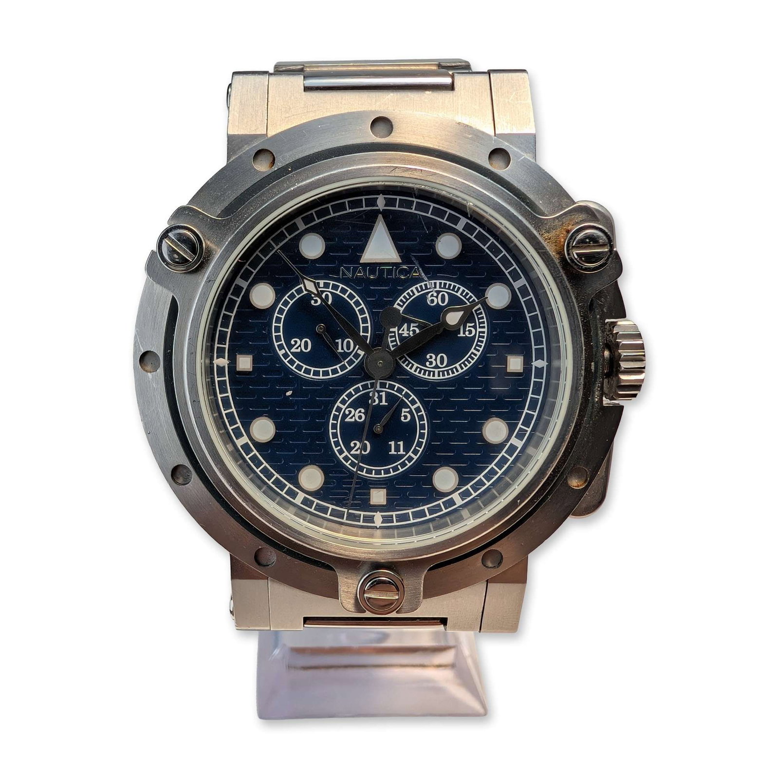 Nautica Stainless Steel Men's Chronograph Wristwatch: Nautica Classic. Men's chronograph wristwatch in stainless steel, featuring a navy blue dial with a textured horizontal grid pattern. The dial includes three sub-dials consisting of a 30-minute counte