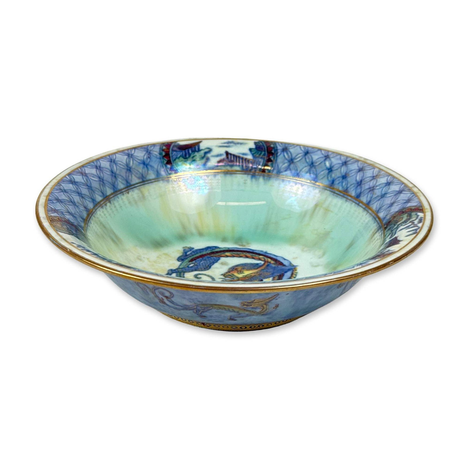 Wedgwood Dragon Lustre Porcelain Bowl, Z4829: Designed by Daisy Makeig-Jones. The interior features a central polychrome dragon medallion against a pale celadon-green and yellow iridescent ground, surrounded by a wide cobalt blue border with a ge