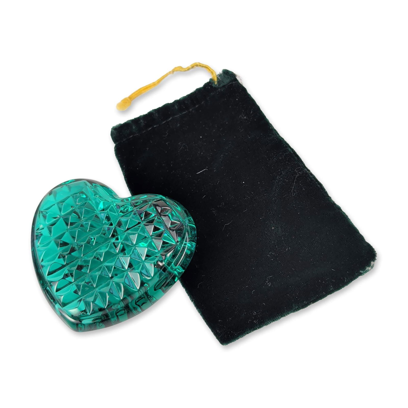 Waterford Crystal Green Glass Heart Paperweight: Waterford. Heart-shaped paperweight or hand cooler in teal green cut glass, featuring a faceted diamond pattern on one face and a radiating linear design on the reverse. Includes a black velvet drawst