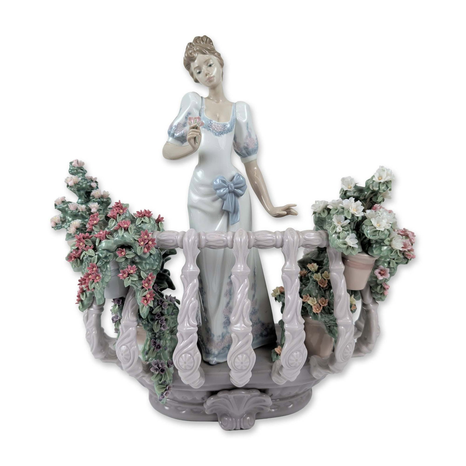 Lladro Far Away Thoughts Porcelain Limited Edition Figurine: Lladro Spanish porcelain figurine titled Far Away Thoughts (Jardines de Atenas), reference number 1798. The piece depicts a young woman in an 18th-century style gown with a blue sash standing on a cur