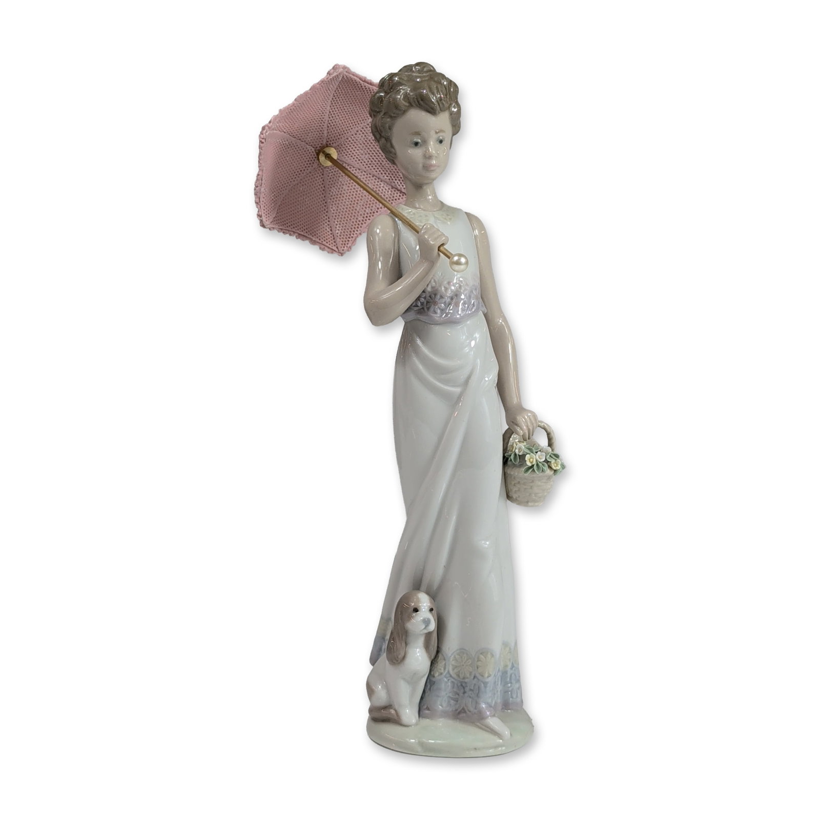 Lladro Spanish Porcelain Garden Classic Figurine 7617: Lladro glazed porcelain figurine titled Garden Classic, model number 7617, depicting a woman in a floor-length gown with a floral-patterned hem. The figure is posed holding a mixed-media lace parasol 