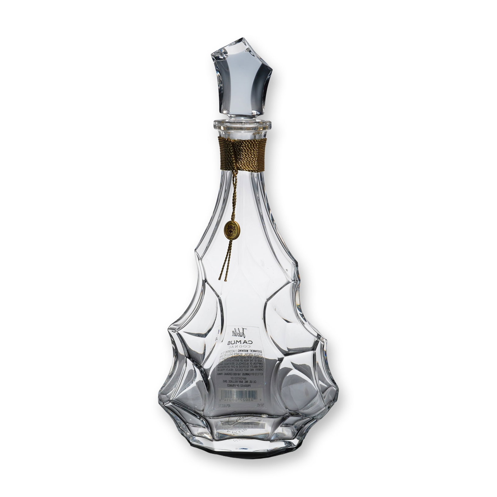 Camus Jubilee Baccarat Cognac Crystal Decanter: Featuring an undulating geometric silhouette with faceted, drapery-like folds and a matching asymmetrical, angular geometric stopper. The neck is wrapped with a decorative gold-toned metallic cord sus