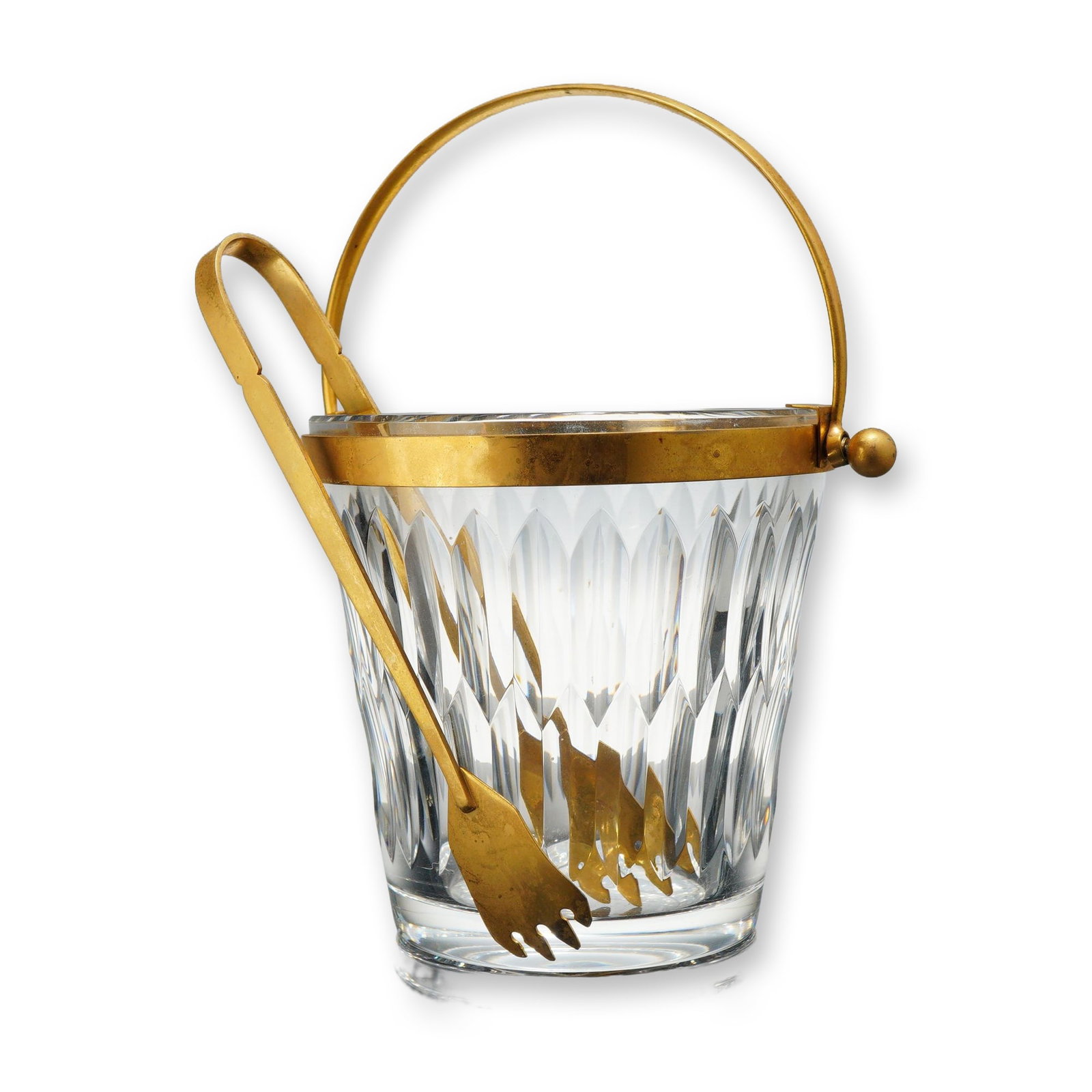 Baccarat Crystal Buckingham Ice Bucket with Gilt Trim and Tongs: This Buckingham model ice bucket by Baccarat is crafted from heavy lead crystal and features a polished gilt-metal rim with an integrated arched bail handle. The vessel is decorated with the Buckingha