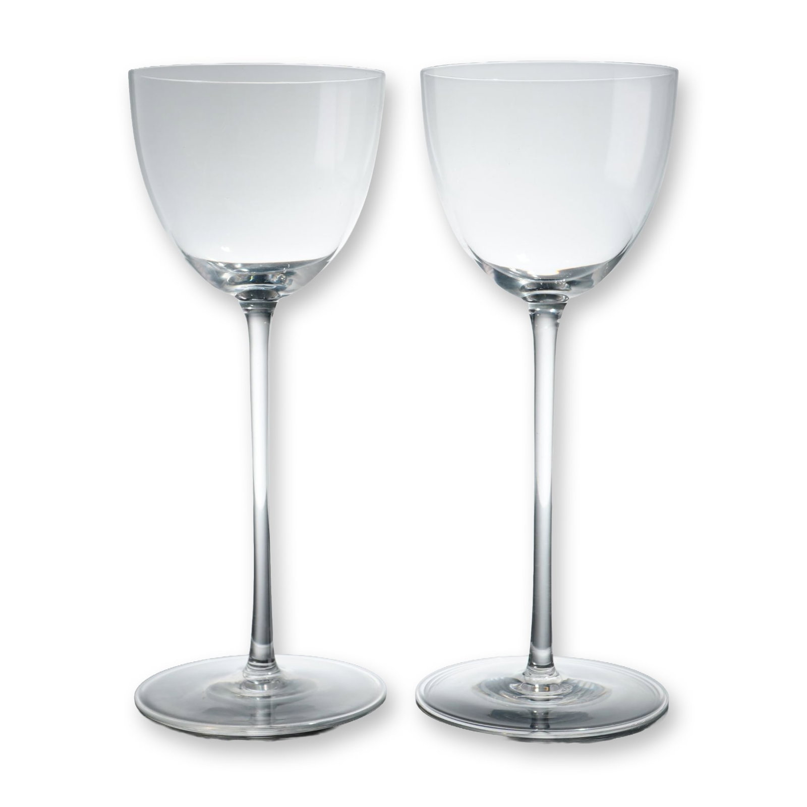 Pair of Baccarat Crystal Perfection Wine Glasses: Pair of wine glasses in the Perfection pattern. Crafted from clear crystal, each glass features a tulip-form bowl on an elongated, slender cylindrical stem with a flat circular base. The underside of