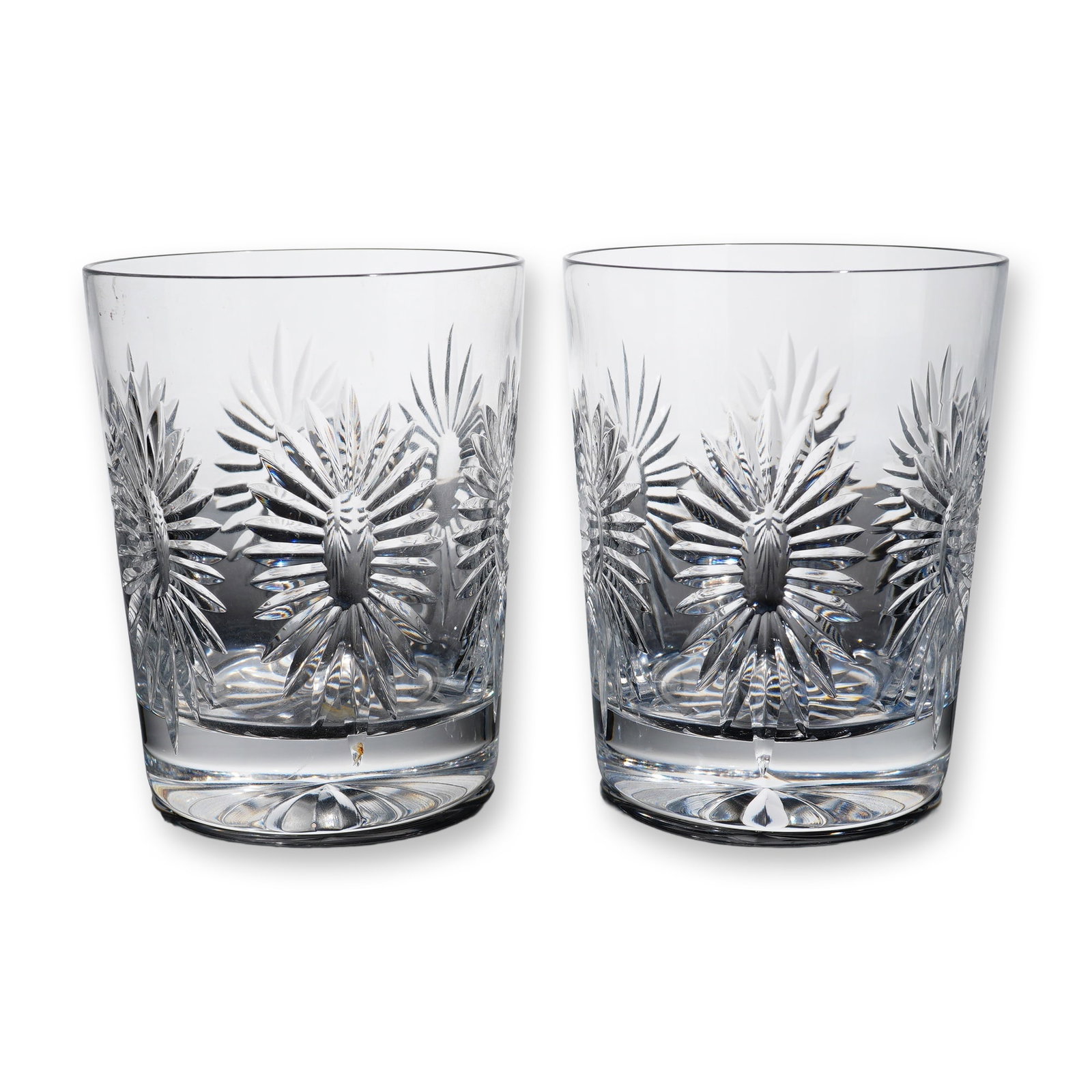 Pair of Waterford Crystal Millennium Double Old-Fashioned Glasses: Waterford Crystal Millennium series double old-fashioned tumblers in lead crystal, featuring a repeating pattern of deeply cut stylized sunbursts radiating from central polished oval facets, with