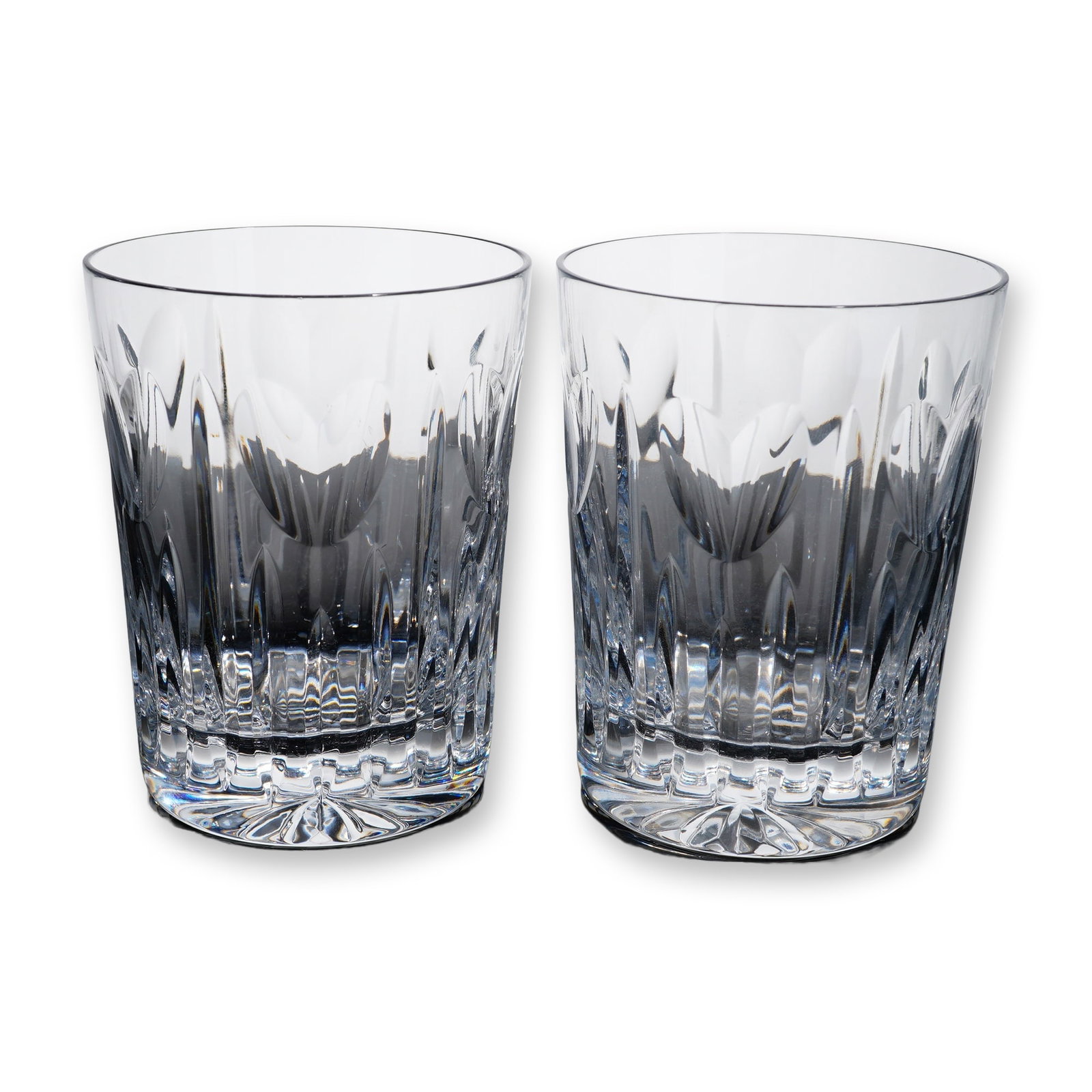 Pair of Waterford Crystal Millennium Series Tumblers: Waterford lead crystal pair of double old fashioned tumblers from the Millennium Series, featuring the Love toast design. The clear crystal bodies are decorated with a central stylized heart cut