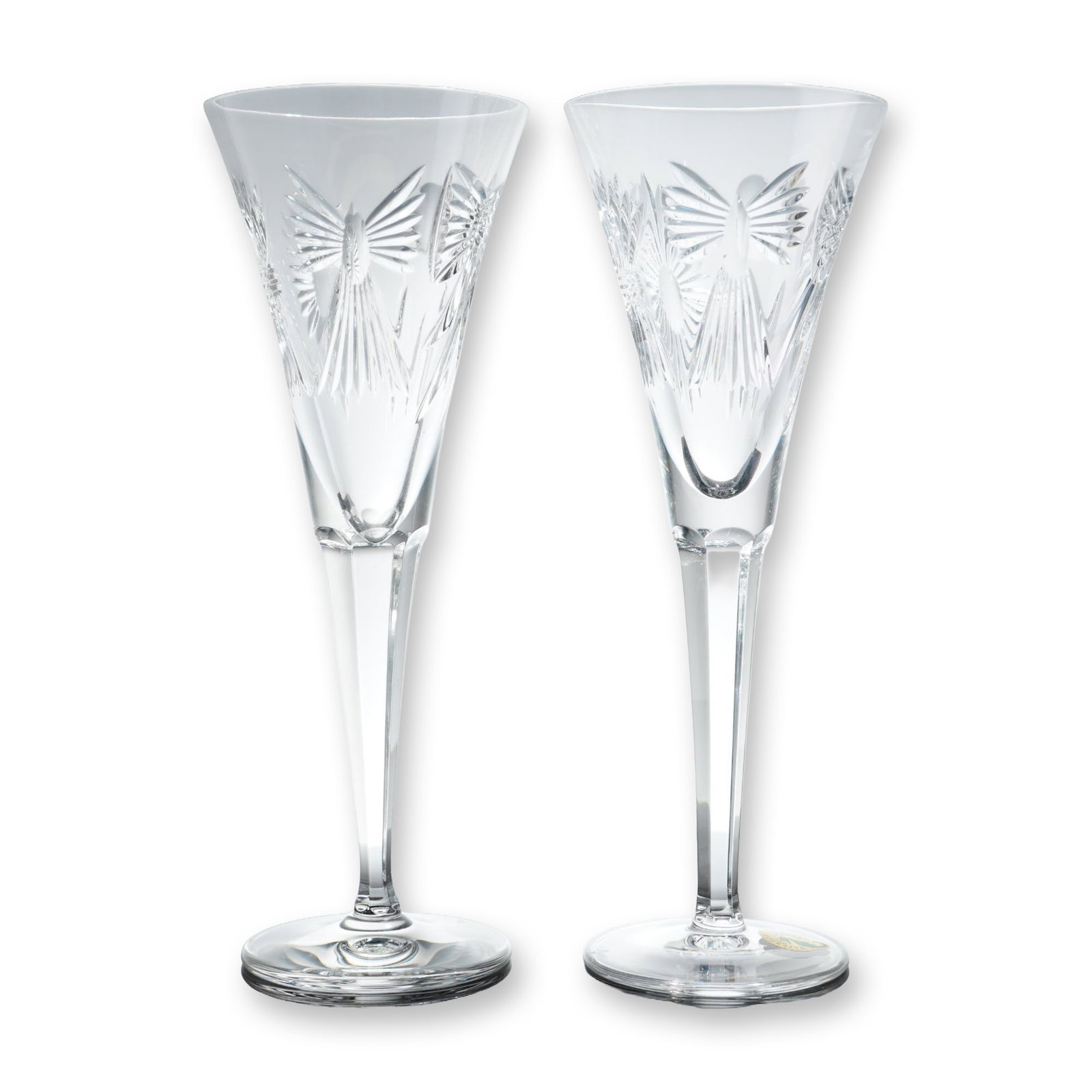 Pair of Waterford Crystal Millennium Toasting Flutes, Peace: Pair of champagne toasting flutes from the Millennium Series Peace collection. Fine lead crystal construction. Each flute features a tapered conical bowl with a deeply cut angel figure having