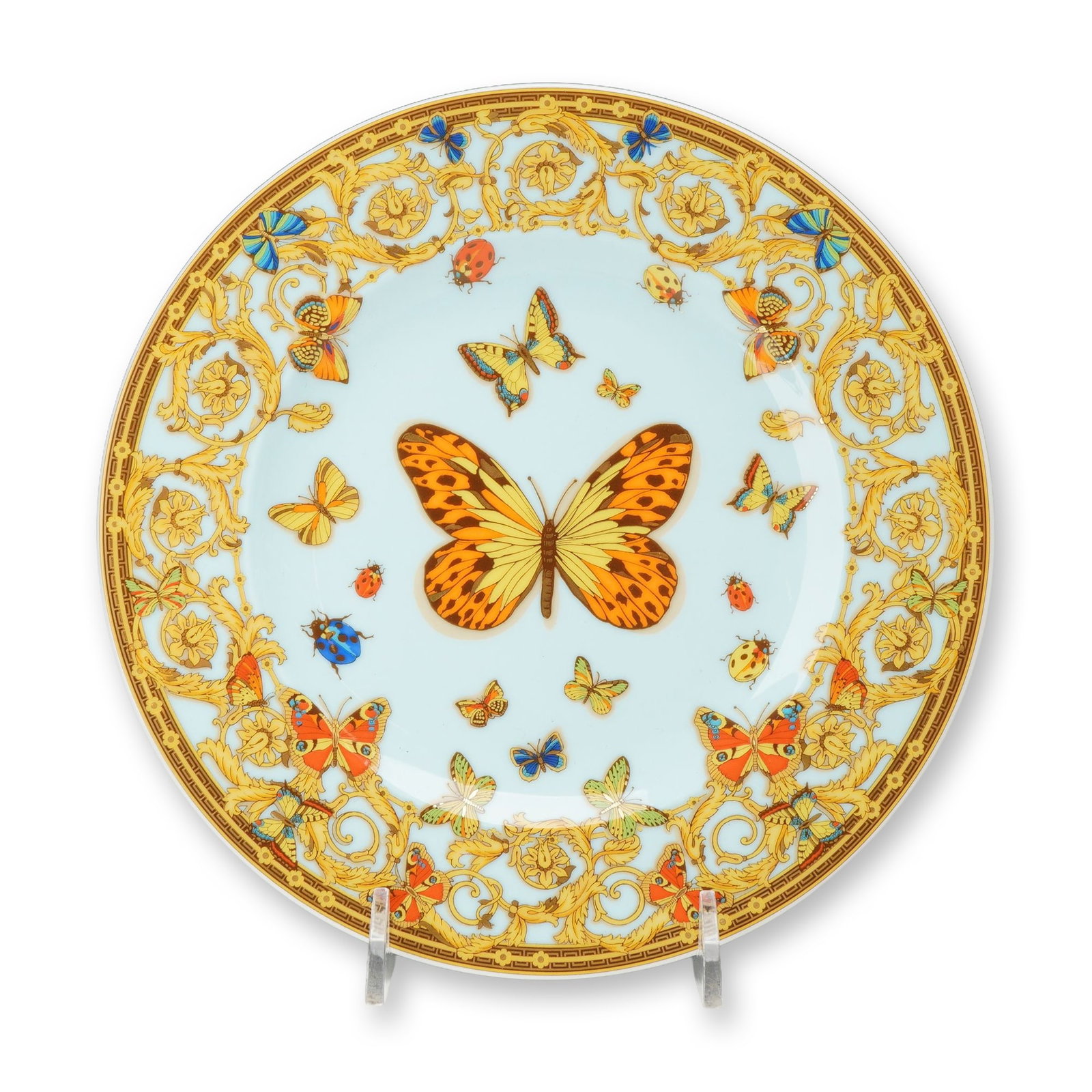 Rosenthal Versace Le Jardin de Versace Porcelain Plate: Rosenthal for Versace fine porcelain bread and butter plate in the Le Jardin de Versace pattern. The plate features a central butterfly motif on a light blue ground, surrounded by smaller insects and 