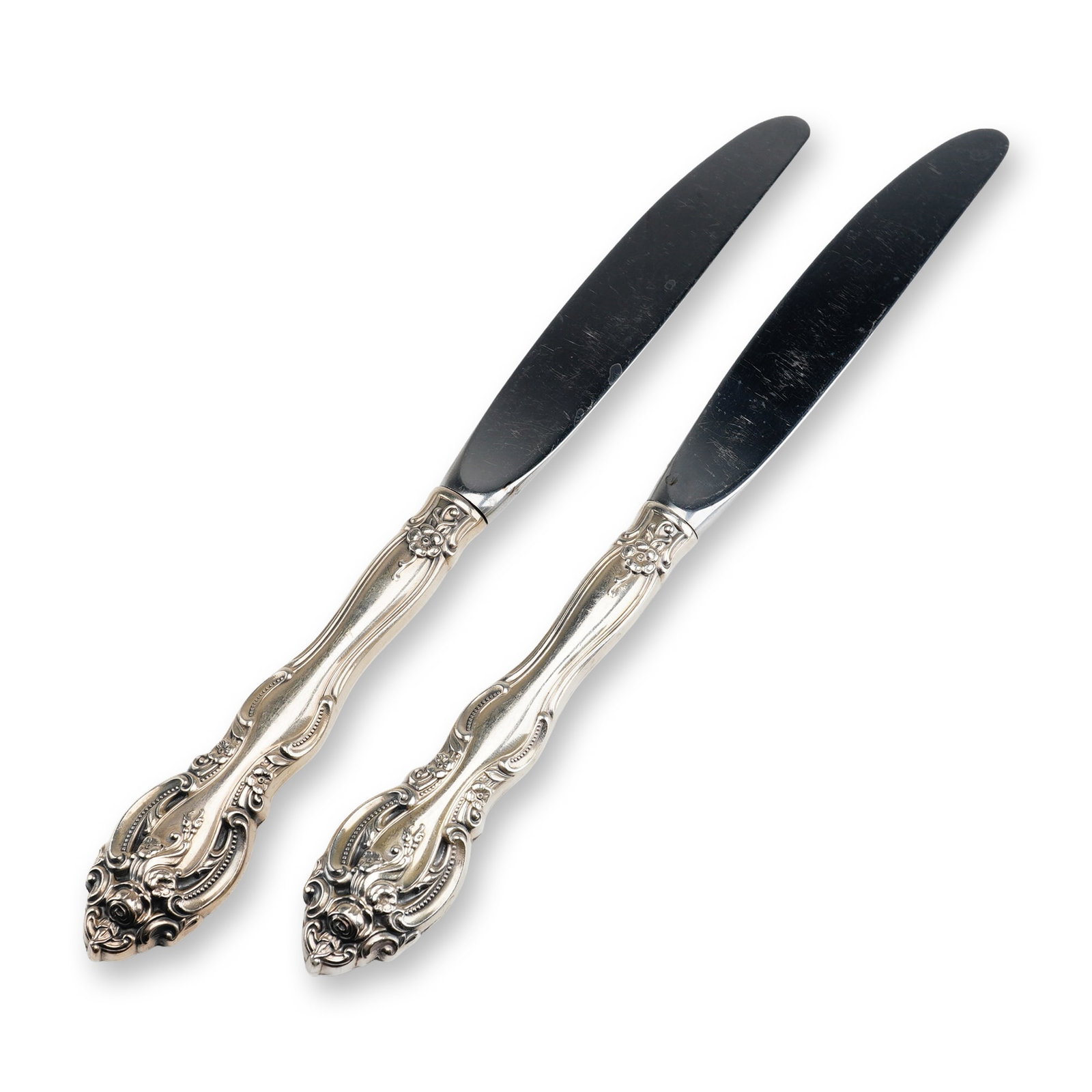 2pc Gorham Sterling Silver and Stainless Steel Dinner Knives, La Scala: This pair of dinner knives is manufactured by the Gorham Manufacturing Company in the La Scala pattern, first introduced in 1964. The handles are constructed of weighted sterling silver and feature el