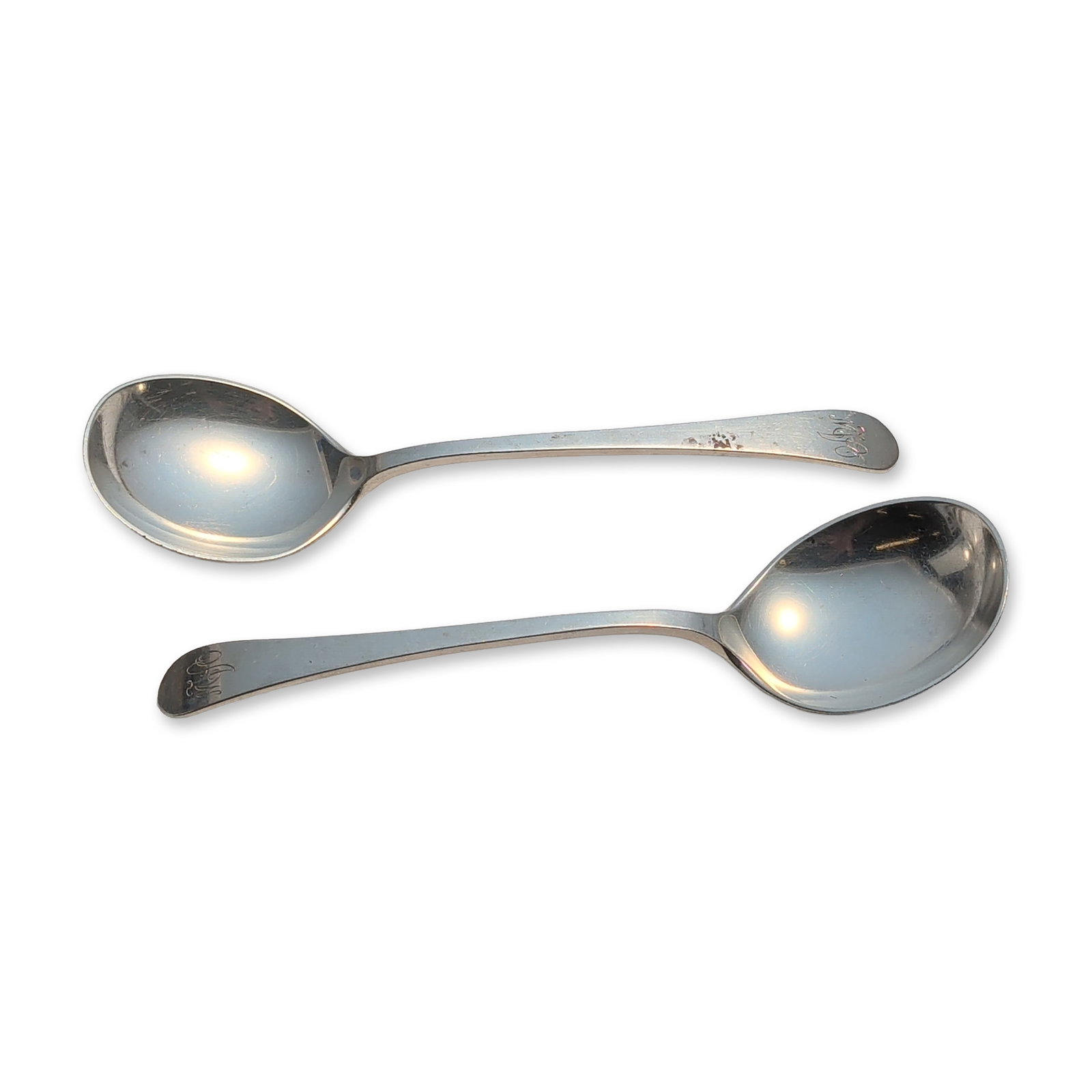 2pc Tuttle Silver Company Sterling Silver Round Soup Spoons, Hannah Hull: Pair of Tuttle sterling silver soup spoons with simple plain handles. The handle terminals are embellished with engraved stylized monograms, while the reverse of each handle is stamped STERLING alongs