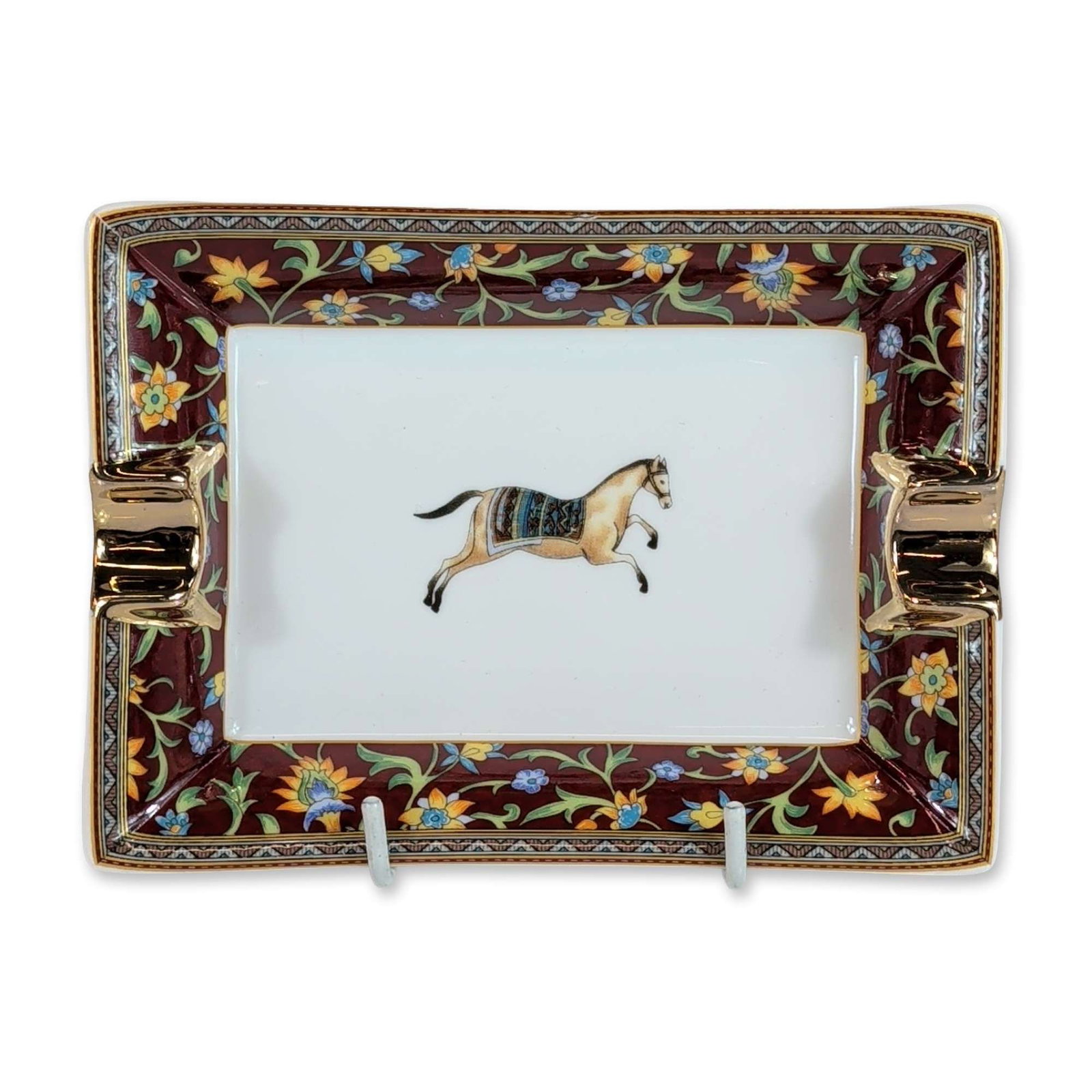 Hermes Paris Cheval d'Orient Porcelain Ashtray: Hermes Paris porcelain ashtray or vide-poche in the Cheval d'Orient pattern. The rectangular dish features a central polychrome depiction of a caparisoned horse. The border is decorated with a Persian