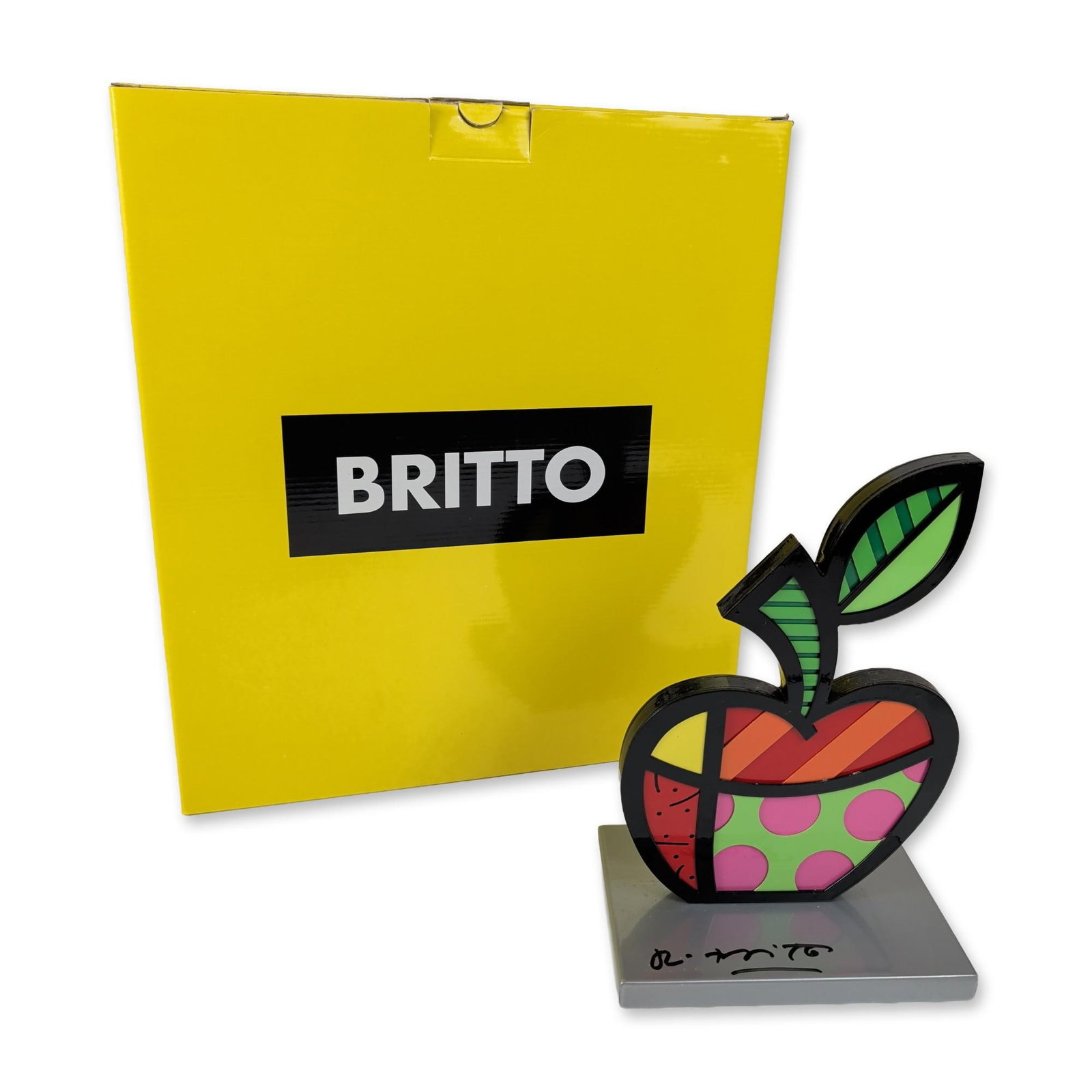 Romero Britto (Brazilian, b. 1963) Apple Sculpture, Signed: Romero Britto (Brazilian, b. 1963). Mixed media sculpture titled The Big Apple, featuring vibrant multi-colored geometric and patterned segments defined by bold black outlines. Mounted on a square sil