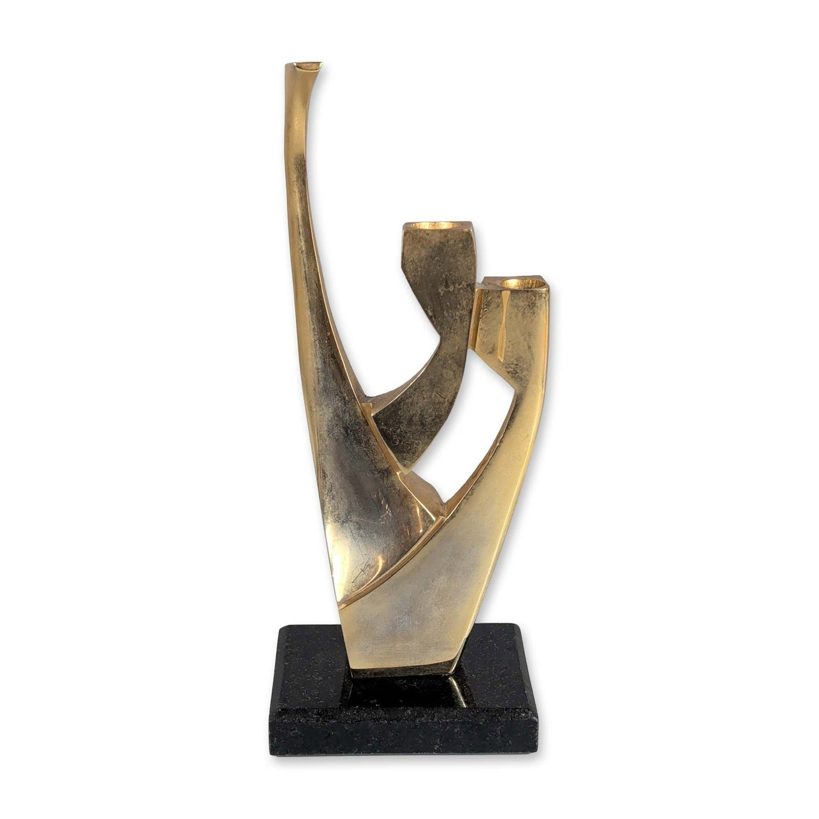 Bezalel Shoham Modernist 24 kt Gold Plated Candleholder: Bezalel Shoham (Israeli). Modernist abstract sculpture in 24K gold-plated metal, featuring sweeping angular and curved forms. Mounted on a rectangular black stone plinth. Incised signature B. SHOHAM, 