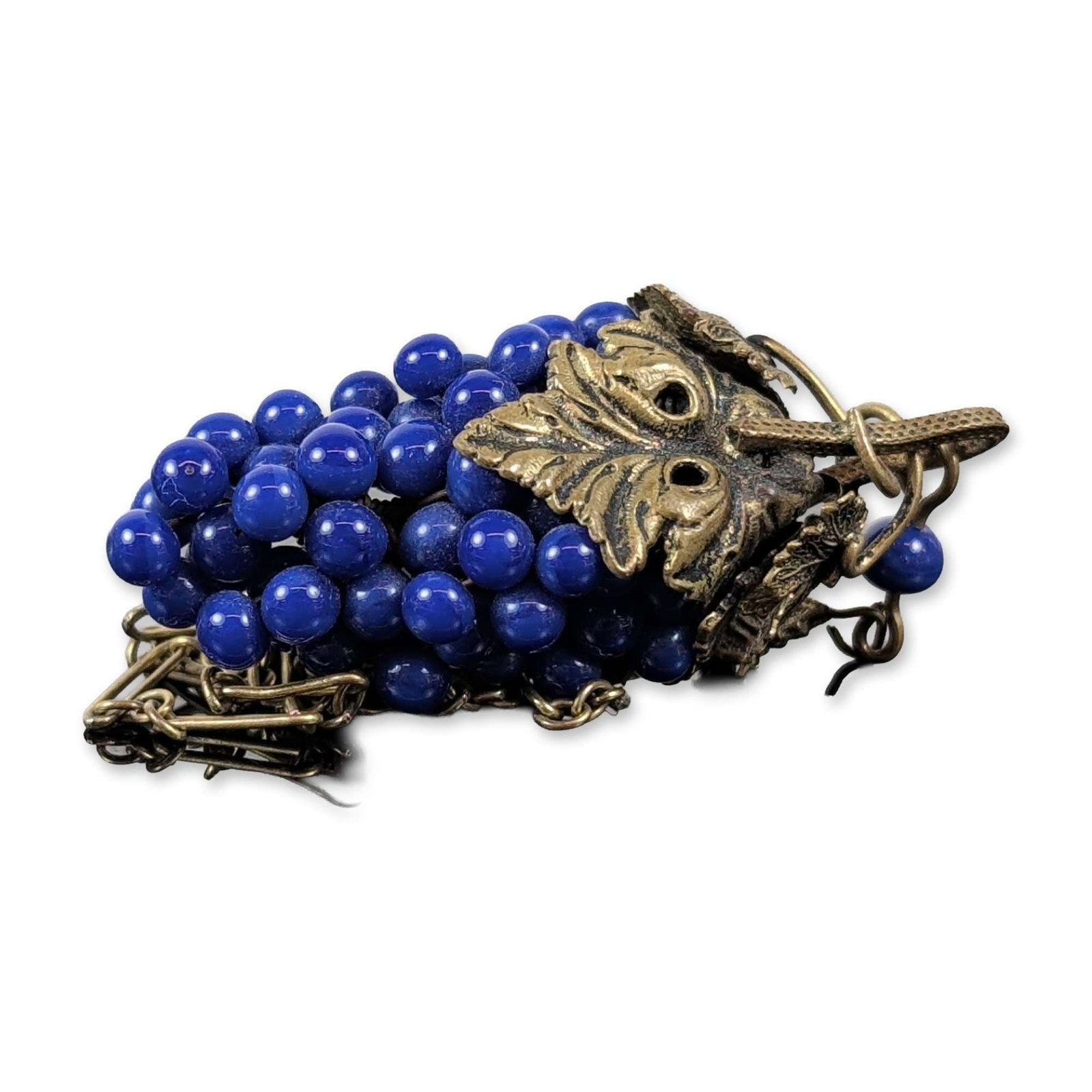 Vintage Lapis Grape Cluster Pendant Necklace: Vintage figural pendant necklace featuring a grape cluster composed of spherical deep blue lapis beads. The pendant is surmounted by cast brass leaves and a textured stem, accompanied by a small leaf 