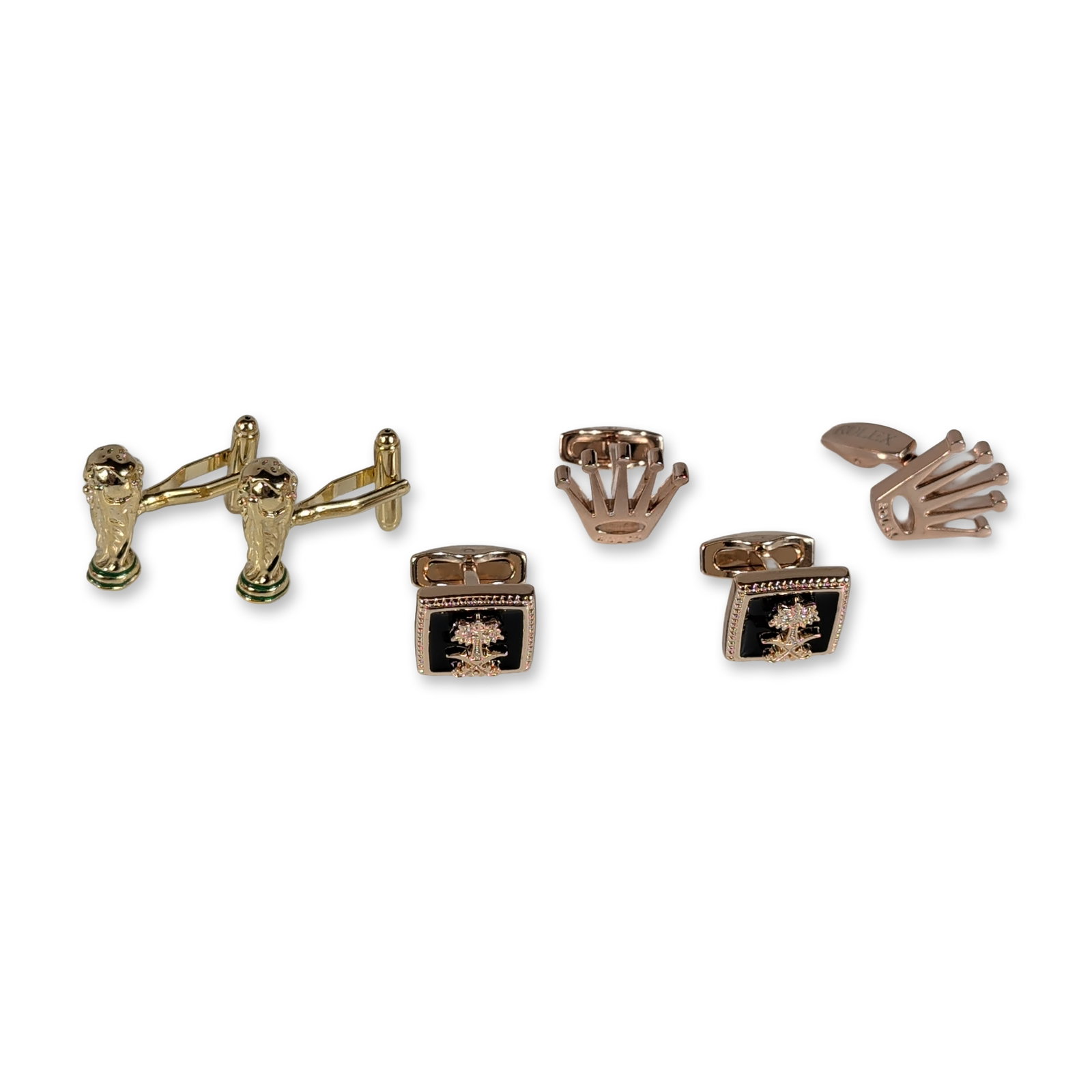 3 pairs World Cup, Rolex and Novelty Gold-Tone Cufflinks: Trio of men's cufflinks in yellow and rose gold-tone metals. Includes a pair of rose gold-tone crown-form cufflinks marked ROLEX on the toggle bars. A second pair features square rose gold-tone mounts