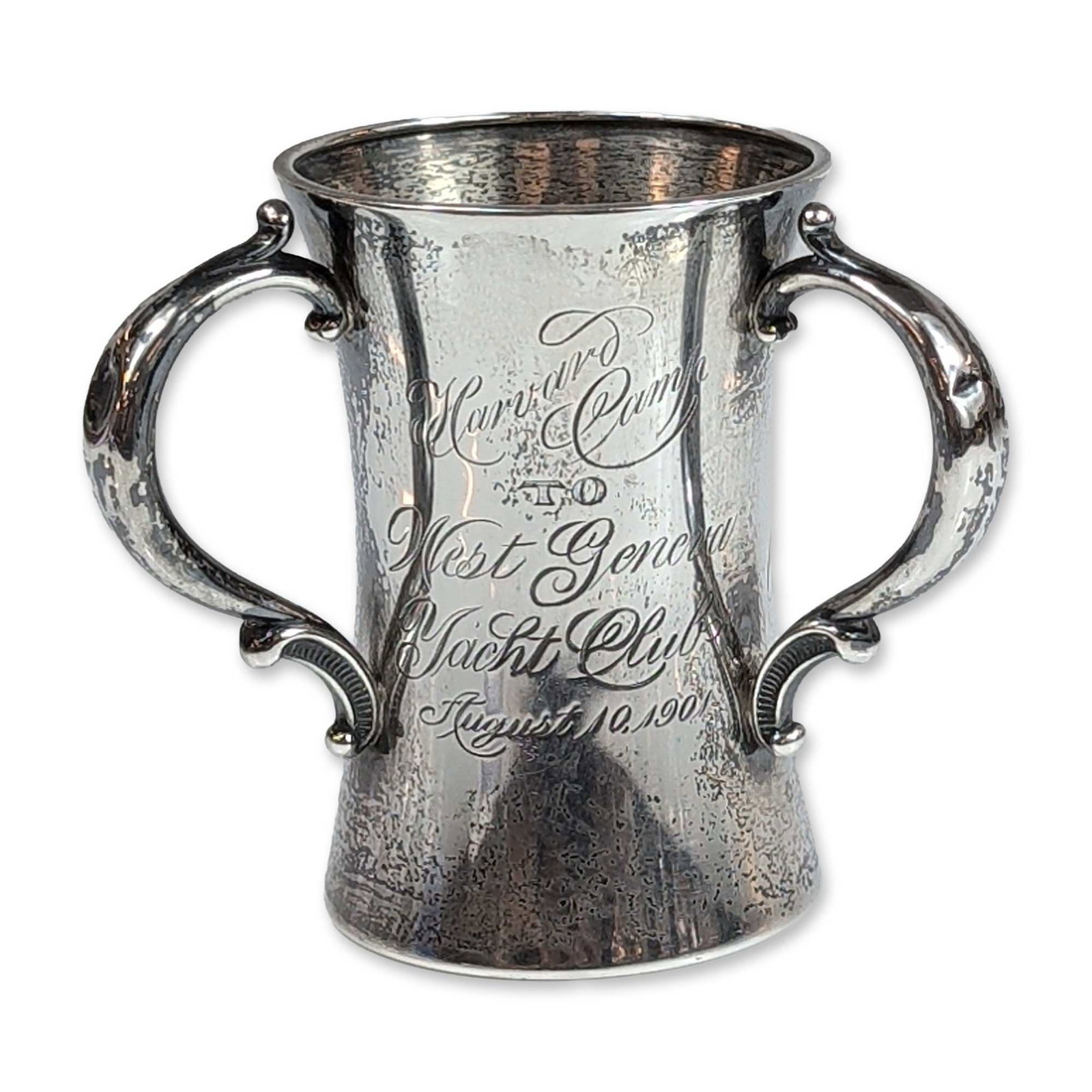 John W. Reddall & Co. Sterling Silver Small Tyg, Yachting Trophy: Hourglass-form vessel in sterling silver, featuring ornate foliate-scroll handles and commemorative script engraving. The face is engraved Harvard West Geneva Yacht Club August 10, 1901. John W. Redda
