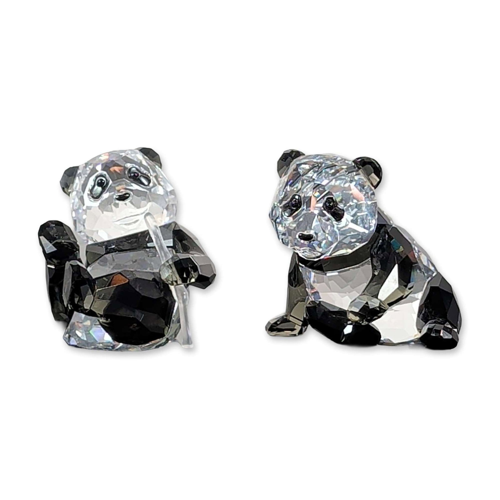 Pair of Swarovski Crystal 2008 Annual Edition Panda Cubs: Swarovski. Pair of faceted lead crystal figurines from the 2008 Annual Edition Endangered Species collection, depicting two panda cubs. The figures are constructed from clear and jet-black faceted cry