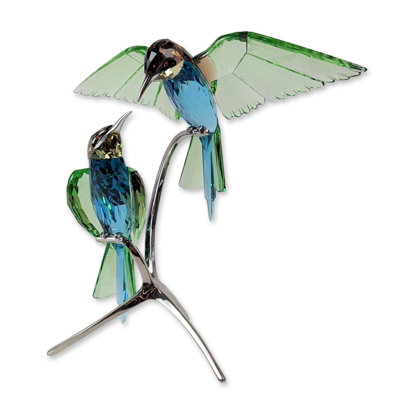 Swarovski Crystal Bee-Eaters Paradise Birds Figurine: Swarovski. Bee-Eaters figurine from the Birds of Paradise collection, designed in peridot green, turquoise blue, and smoky quartz faceted crystal. The composition depicts two birds with red crystal ey