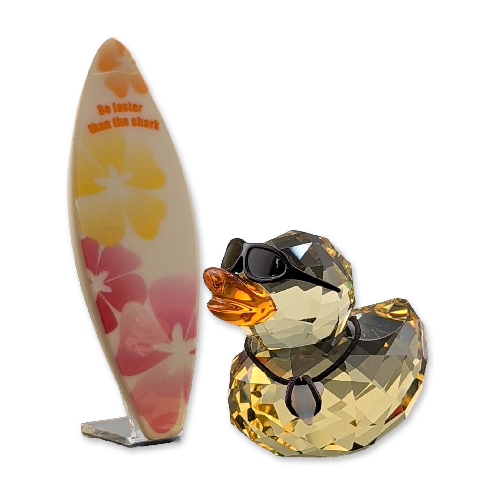 4pc Swarovski Sunny Steve Crystal Duck Figurine: Swarovski Happy Ducks series figurine titled Sunny Steve, model number 1096743. Faceted lead crystal body in amber tones with an orange crystal beak. Accessories include black sunglasses, a cord neckl