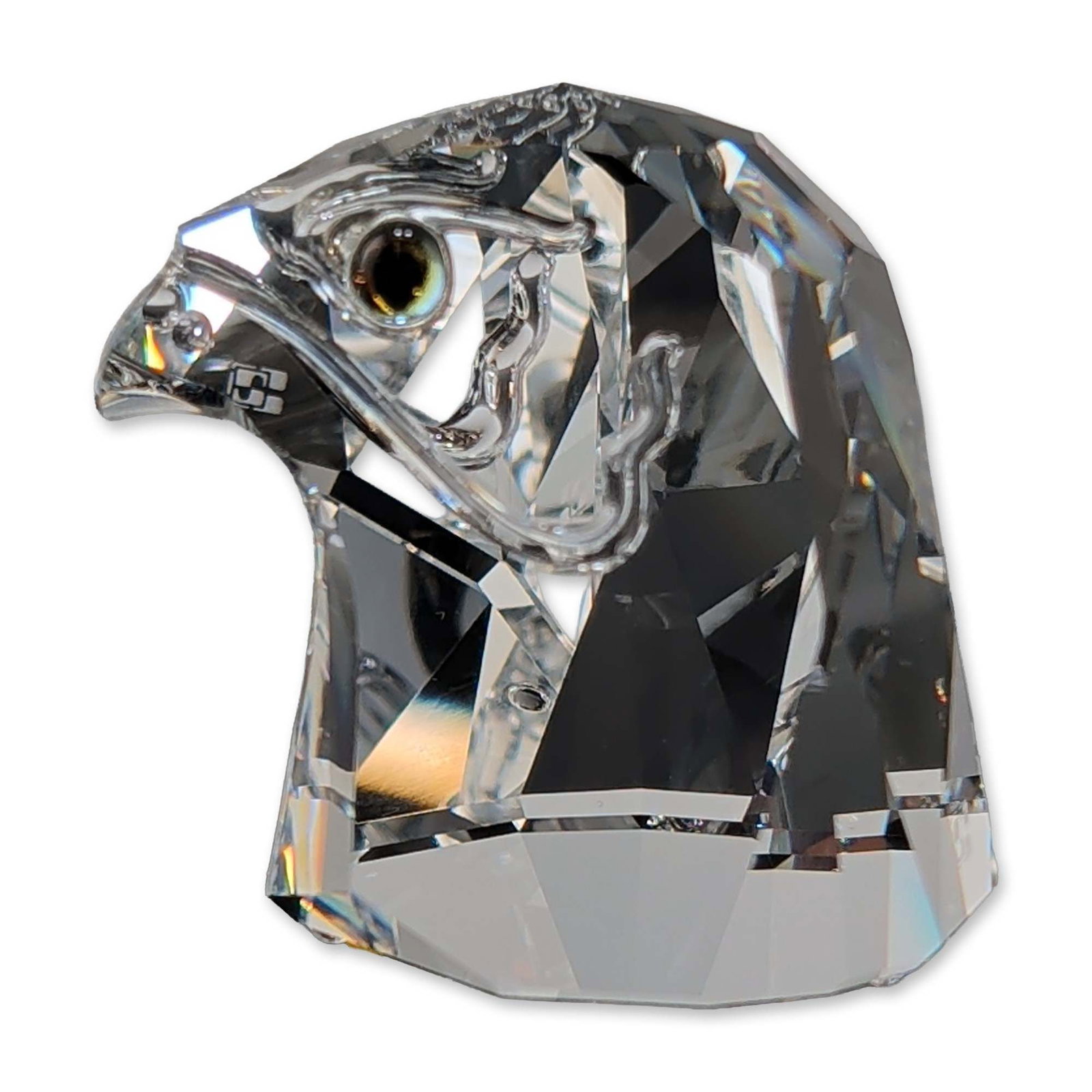 Swarovski Selection Crystal Falcon Head Figurine: Swarovski Selection falcon head figurine in faceted lead crystal. The sculpture features a stylized raptor head with precision-cut facets, and dark inset eyes. Marked with the laser-etched Swarovski S