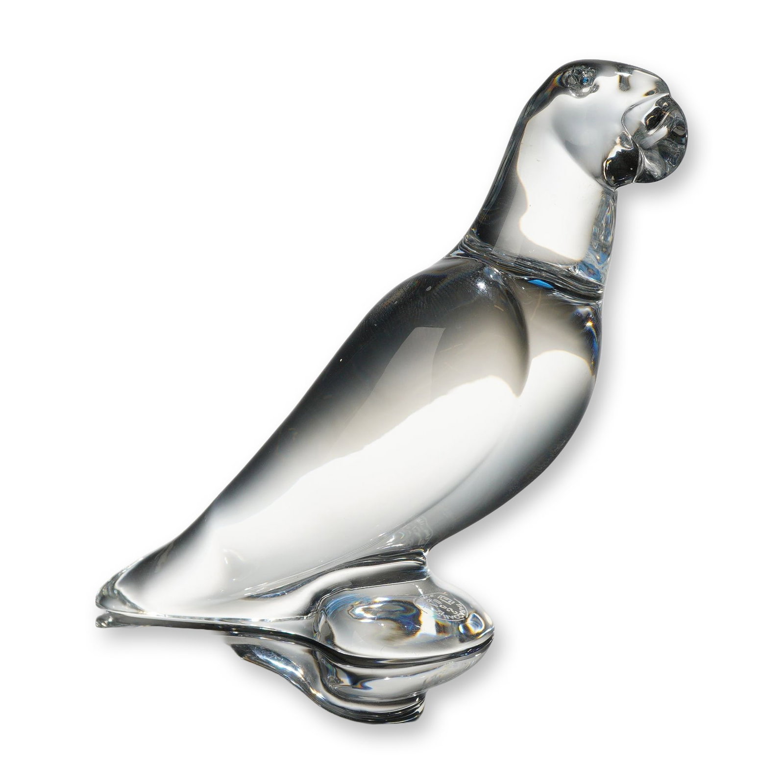 Baccarat France Clear Crystal Parrot Figurine: A clear lead crystal figurine of a parrot produced by Baccarat, France. The stylized bird is depicted in a perched stance with its head slightly turned, featuring the smooth, fluid lines characteristi