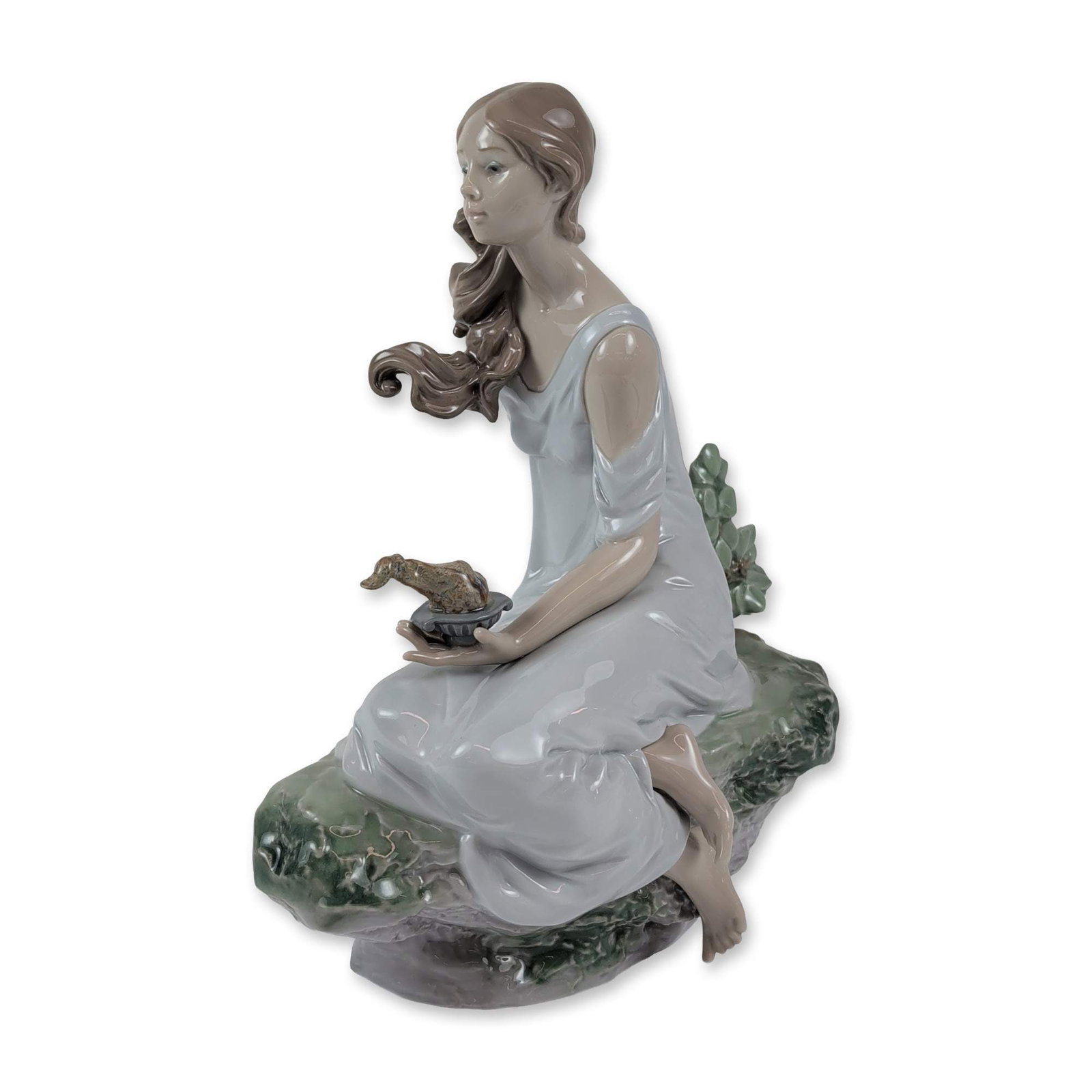 Lladro Limited Edition The Muse Porcelain Figurine: Lladro Privilege limited edition glazed porcelain figurine titled The Muse (La Musa). The sculpture depicts a seated young woman with flowing hair, dressed in a pale lavender-blue gown, positioned upo