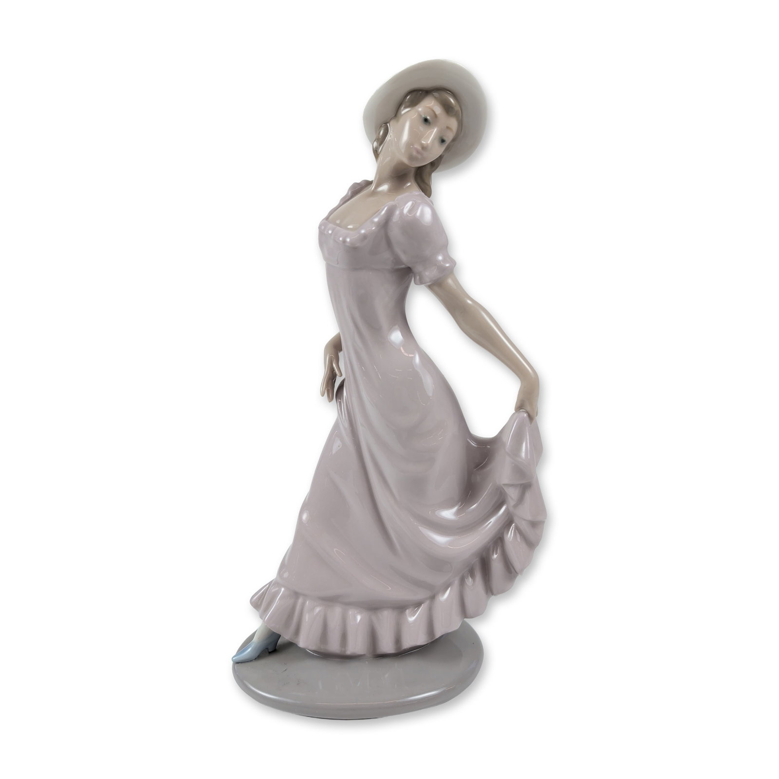 Nao by Lladro Glazed Porcelain Elegant Lady Figurine: This glazed porcelain piece portrays a slender young woman in a flowing mauve dress with a ruffled hem, gracefully posed with her hands lifting the back of her skirt. She wears a wide-brimmed matching