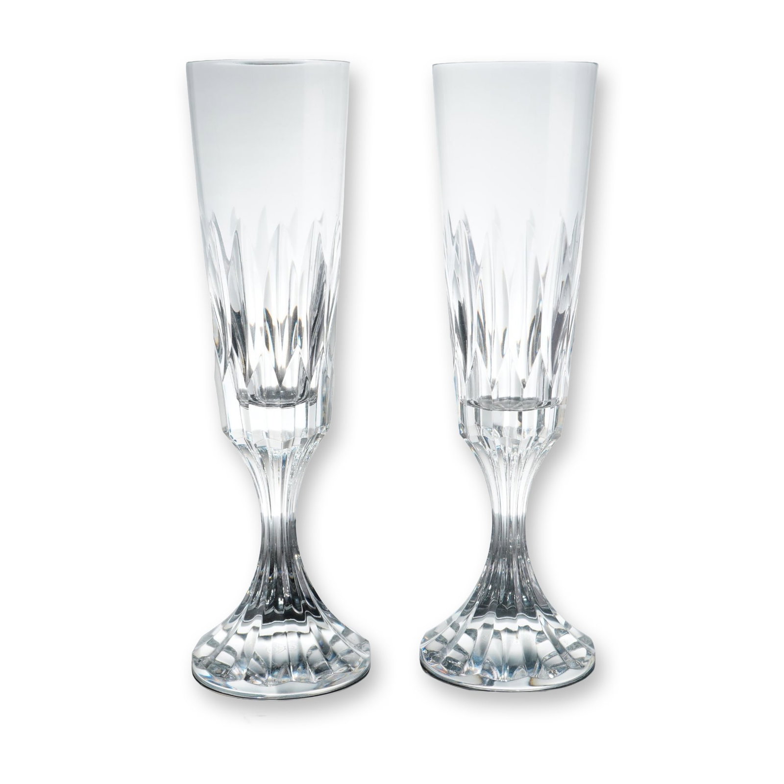 Pair of Baccarat Assas Crystal Champagne Flutes: Baccarat (France). Pair of champagne flutes in lead crystal, featuring the Assas pattern. Each piece is decorated with deep vertical wedge cuts to the lower portion of the bowl, a faceted stem, and a 