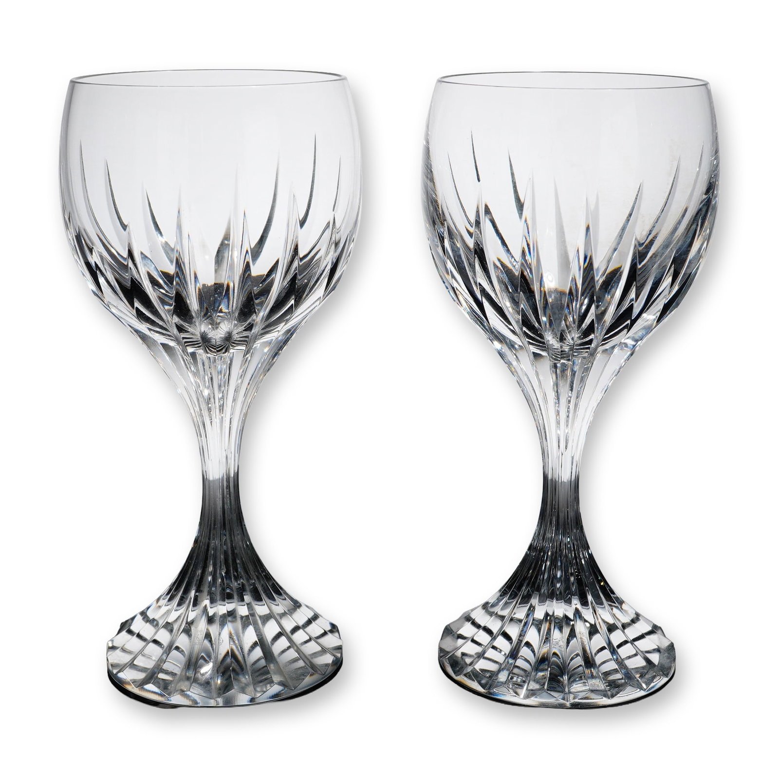 Pair of Baccarat Massena Crystal Wine Glasses: French. Pair of wine glasses in Baccarat lead crystal, in the Massena pattern. Each features deep, polished vertical bevel cuts on the lower portion of the bowl, transitioning down the stem to a deepl