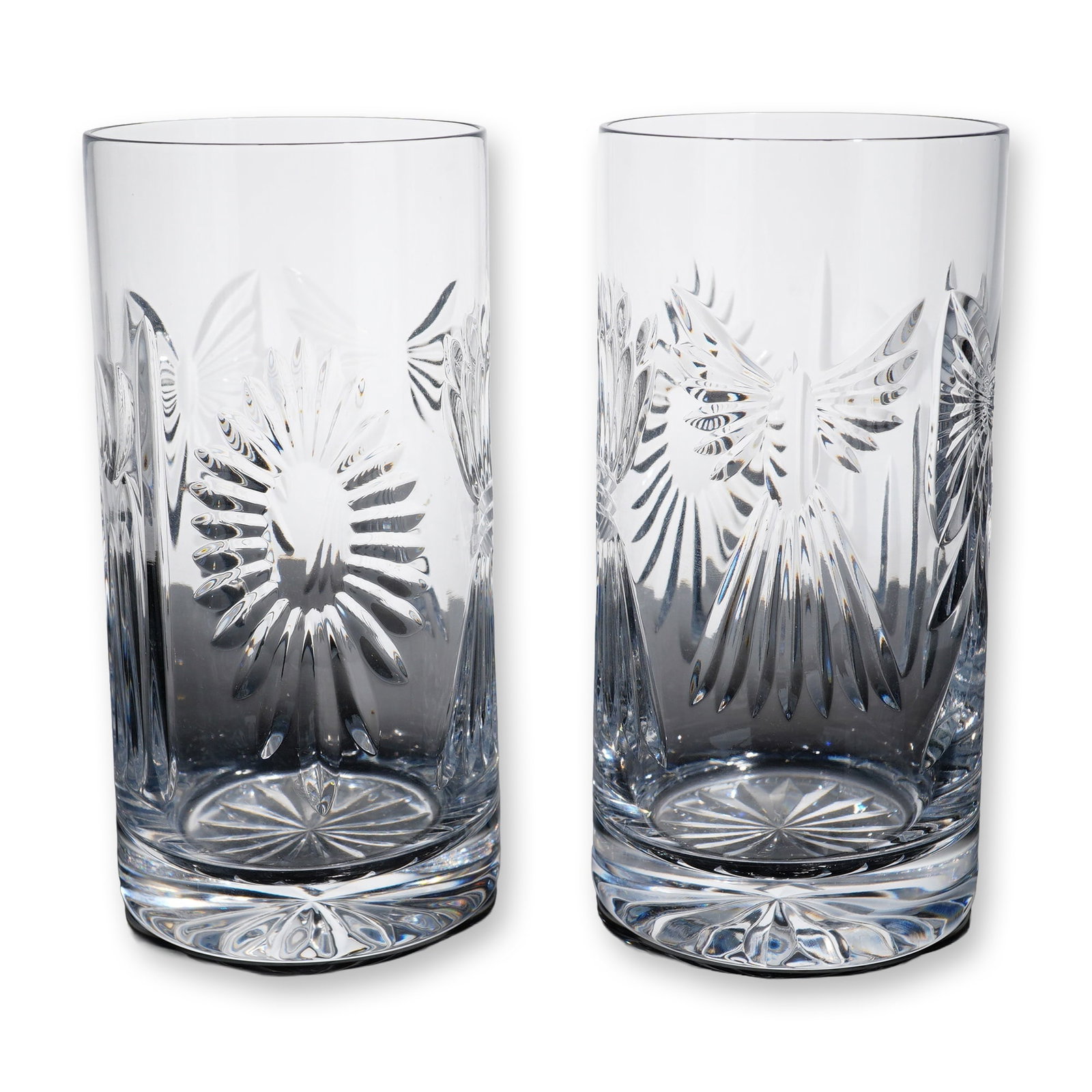 Pair of Waterford Crystal Millennium Series Highball Glasses: Waterford crystal. Pair of highball glasses in heavy lead crystal, featuring detailed miter-cut designs from the Millennium Series collection, including butterfly and starburst motifs with vertical we