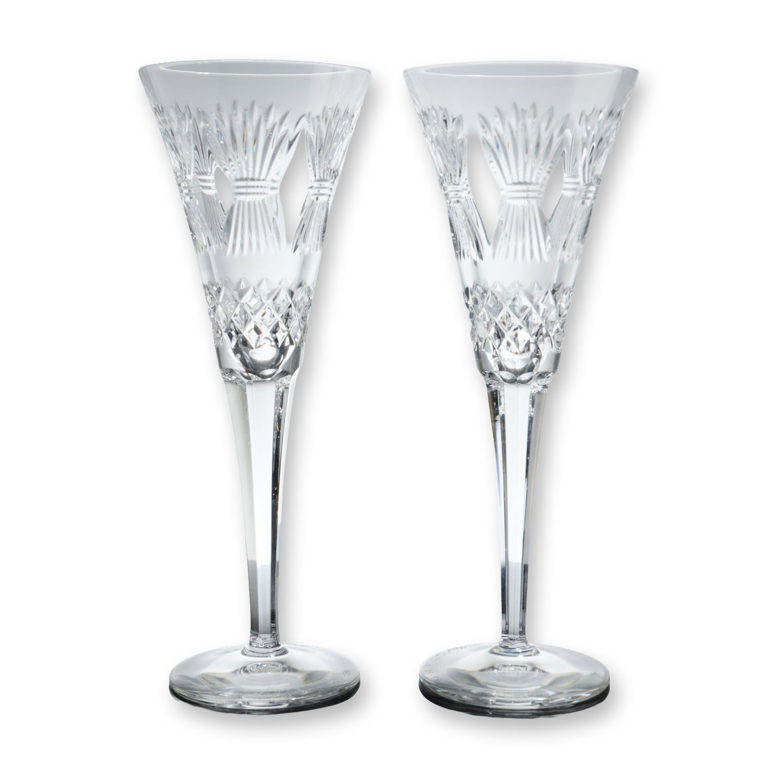 Pair of Waterford Crystal Millennium Toasting Flutes: Waterford Crystal pair of champagne toasting flutes from the Millennium Collection in lead crystal. The conical bowls feature cut decoration consisting of stylized wheat or grass stalks separated by v