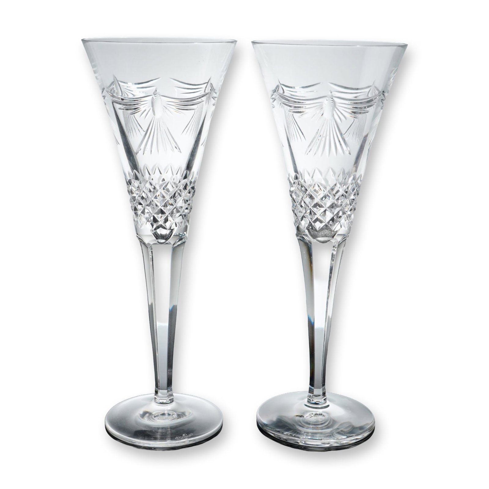 Pair of Waterford Millennium Crystal Toasting Flutes, Peace: Pair of contemporary champagne toasting flutes from the Millennium Collection in the Peace pattern. Crafted from lead crystal, each flute features a tapered conical bowl decorated with a band of diamo