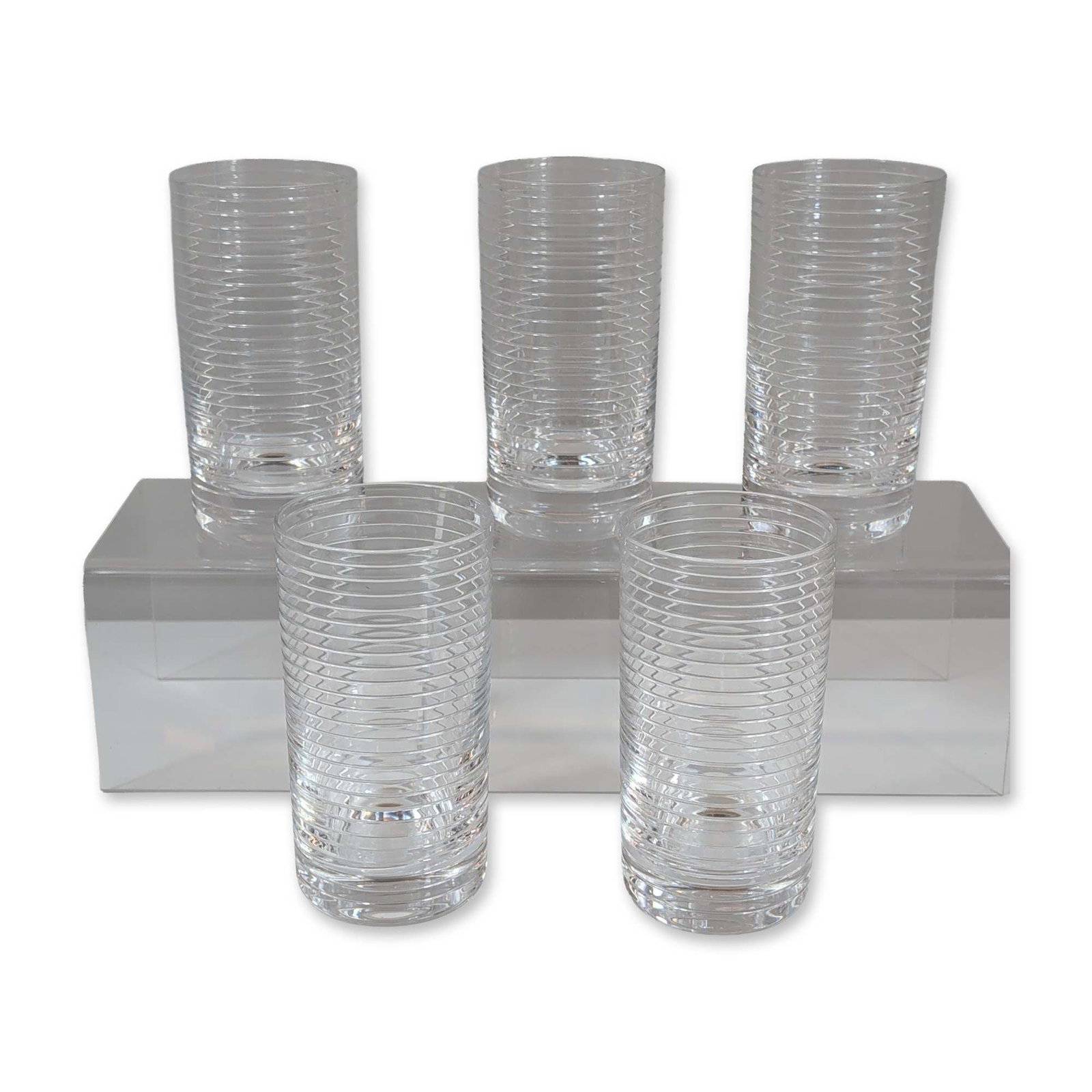 5pc Tiffany & Co. Ribbed Crystal Highball Glasses: Tiffany & Co. Highball tumblers in clear lead crystal, featuring a minimalist design with closely spaced horizontal ribbing from the base to just below the rim. Each glass holds approximately 12 ounce