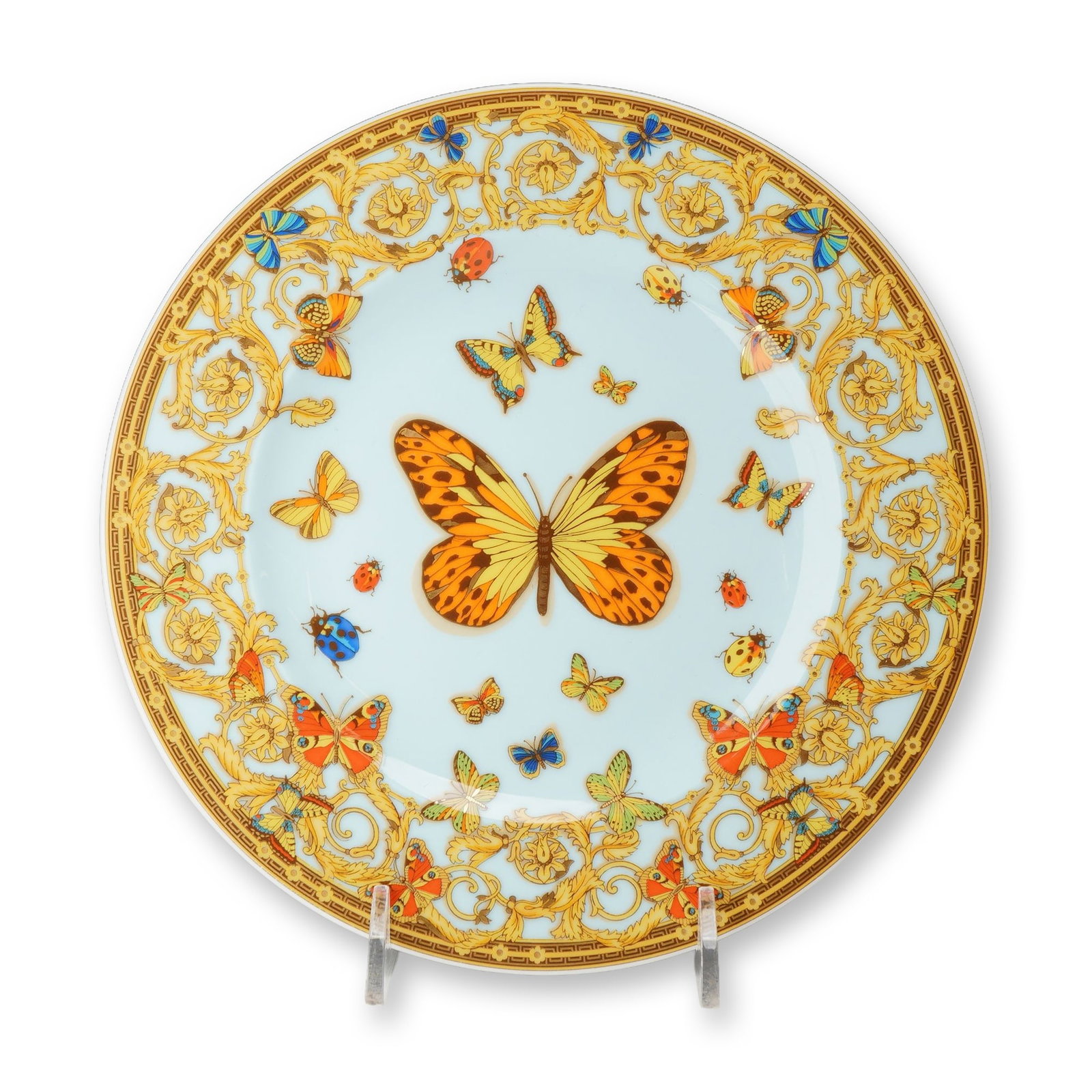 Rosenthal Versace Le Jardin de Versace Bread and Butter Plate: Porcelain bread and butter plate from the Le Jardin de Versace collection. The design features a pale blue ground decorated with polychrome butterflies and ladybugs, centered by a prominent orange and